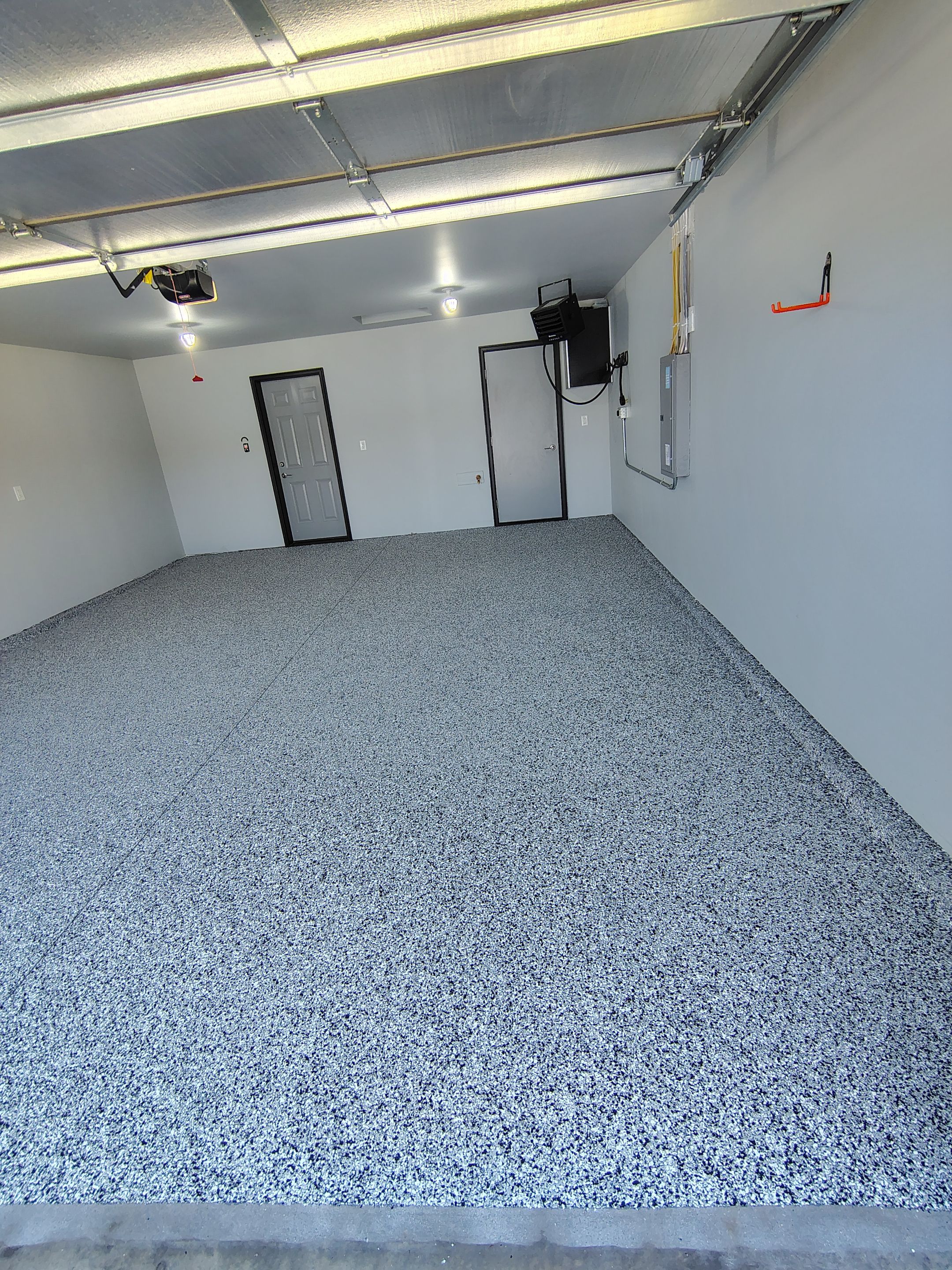 Custom Epoxy Garage Floor Coating Installation in Sioux Falls by Select Painting, Coatings & Garage Cabinets