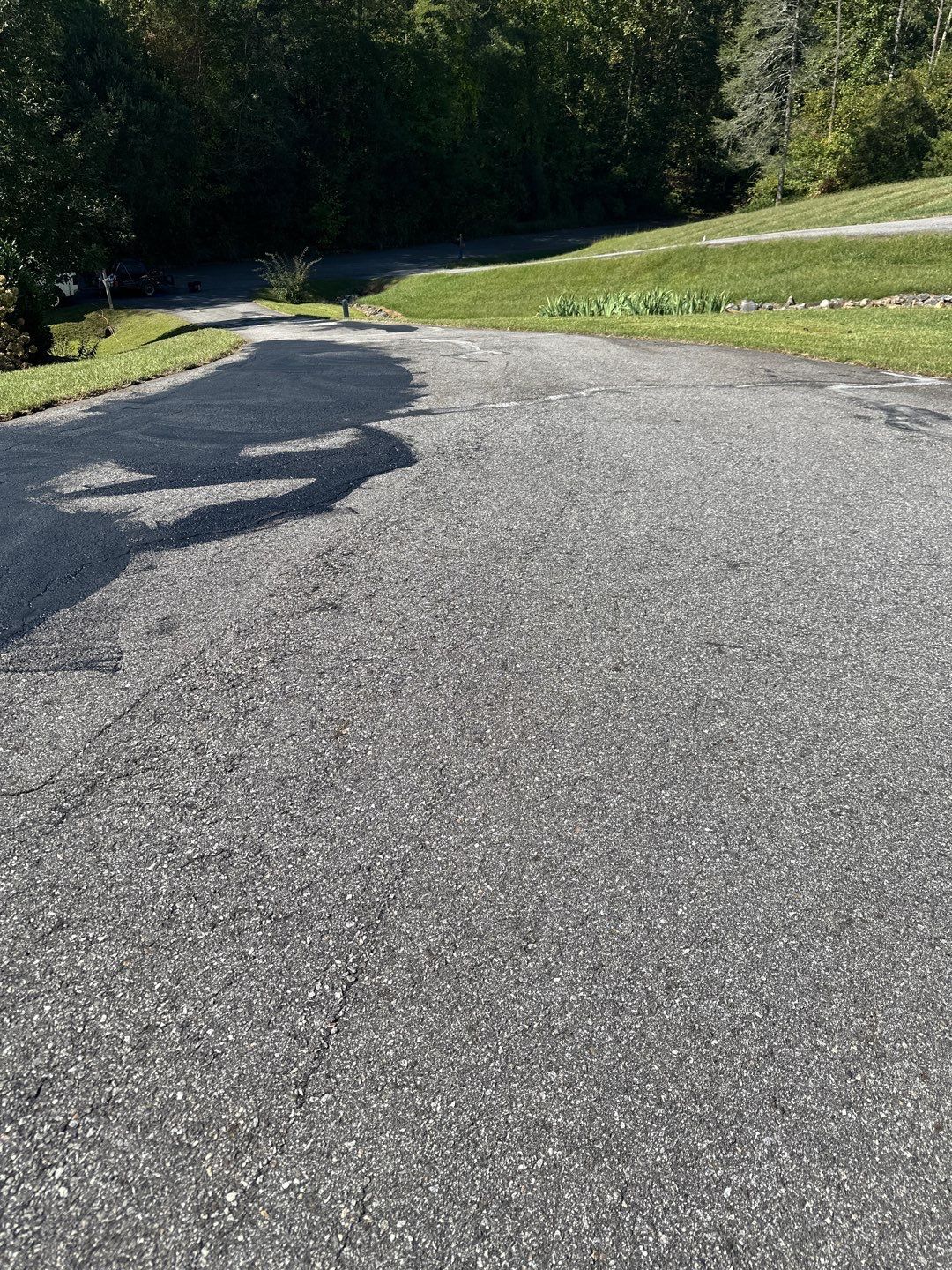 the service being done is power washing the asphalt driveway to remove dirt and stains for a cleaner appearance