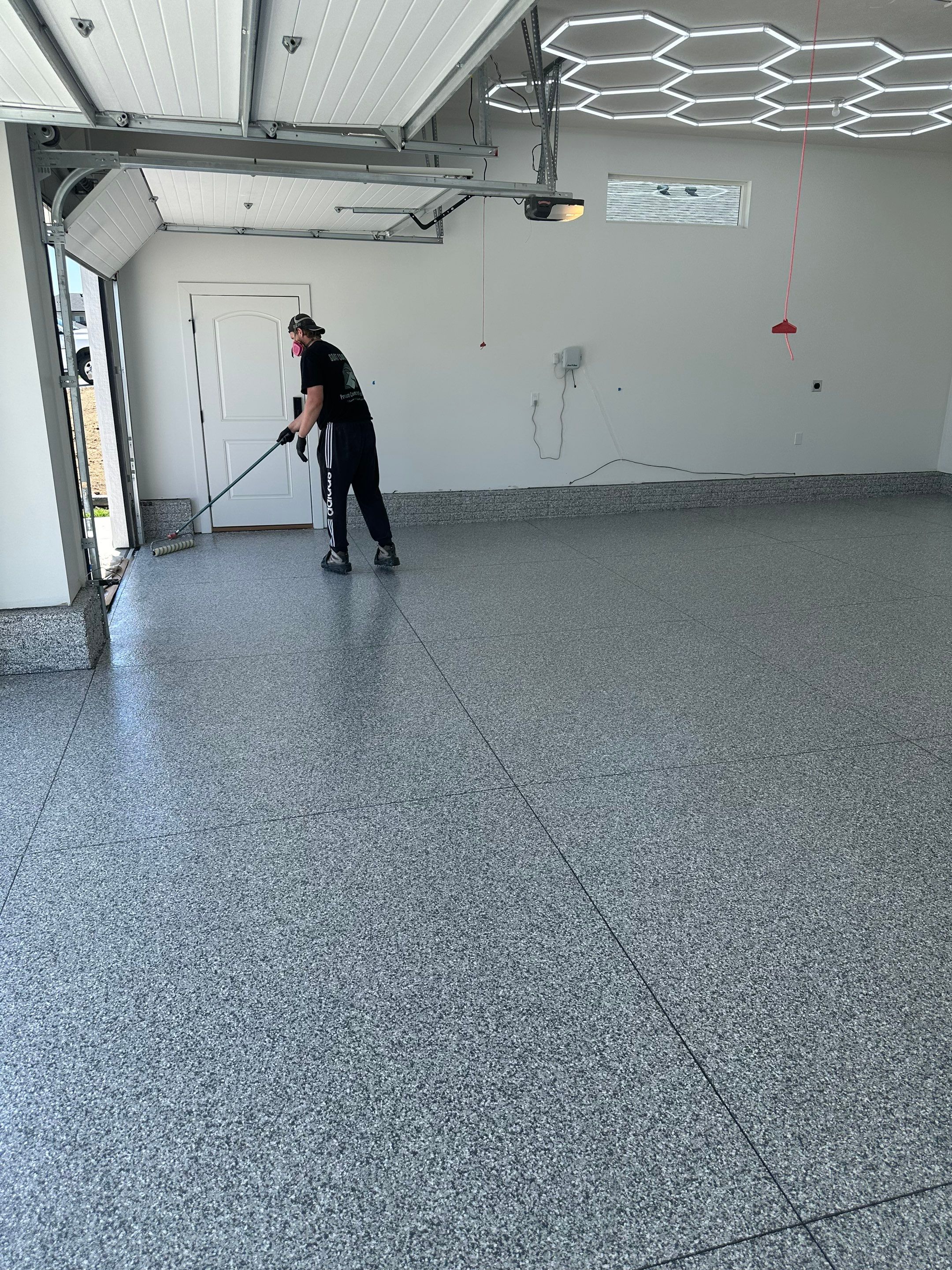 Three-Stall Garage Epoxy Floor Coating and LED Lighting in Lincoln by Goat Coatings