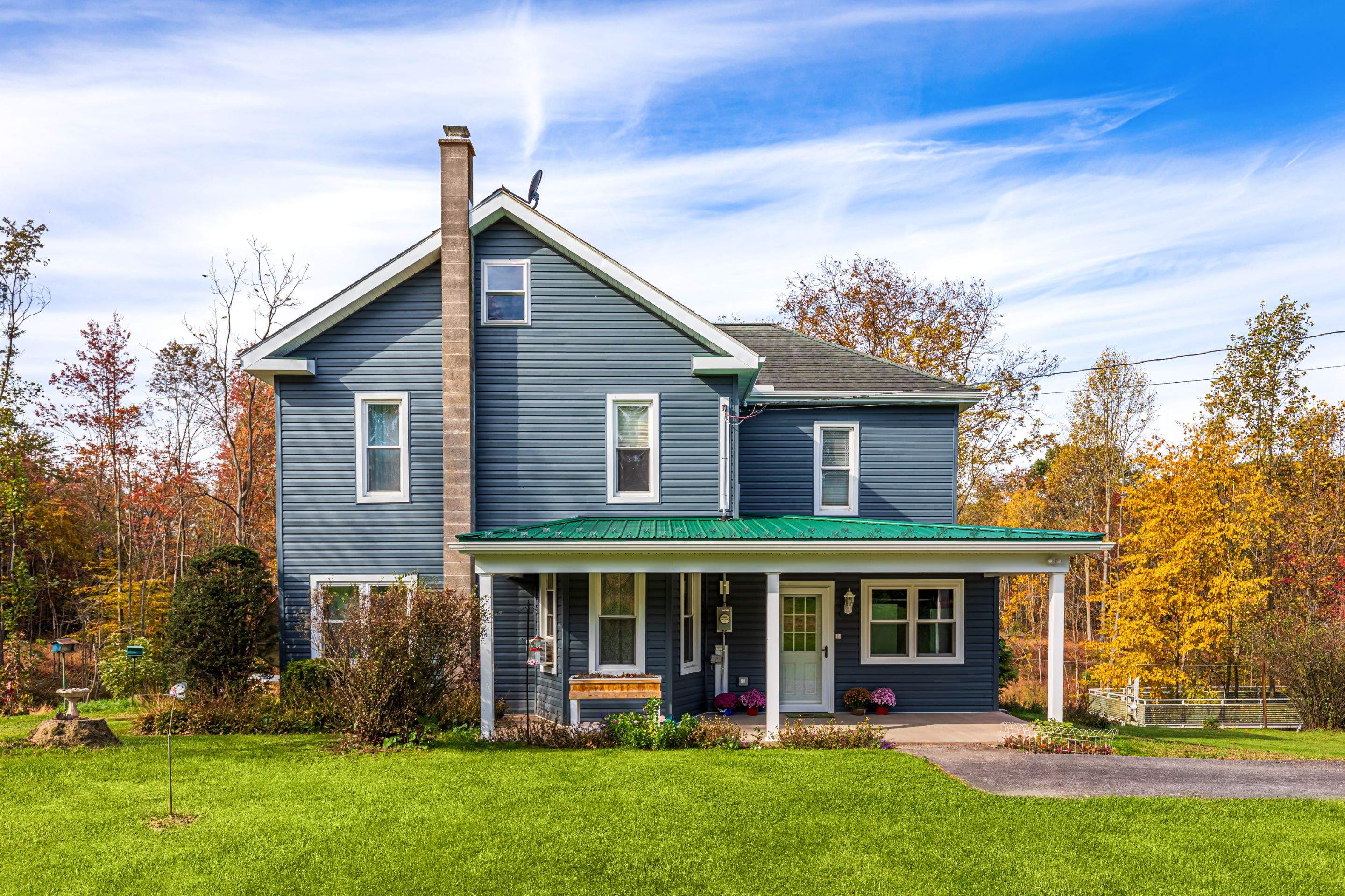Porch roof [green] and new siding by Esh Builders