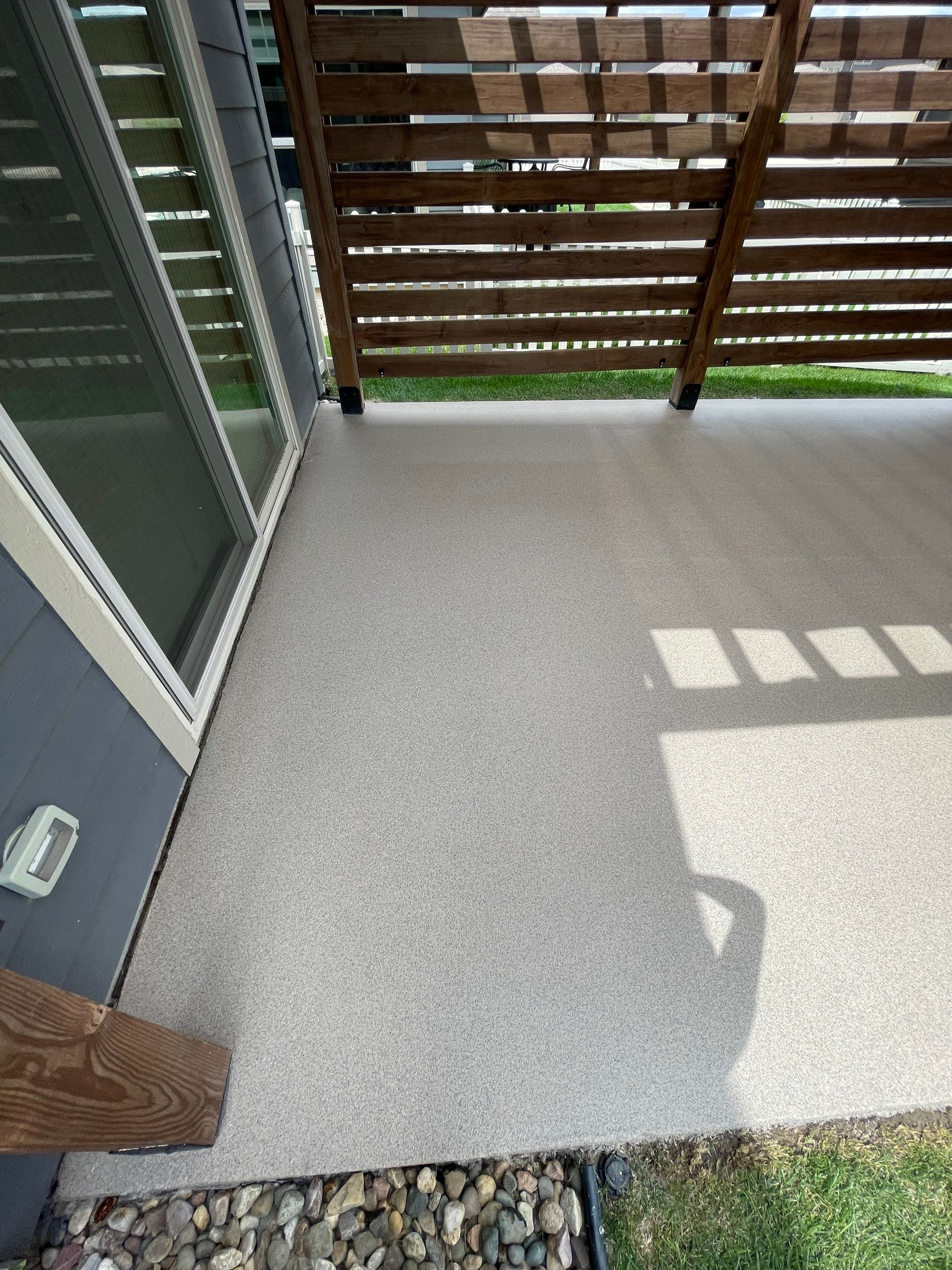 Textured Concrete Patio Coating and Custom Privacy Pergola in Sioux Falls by Select Painting, Coatings & Garage Cabinets