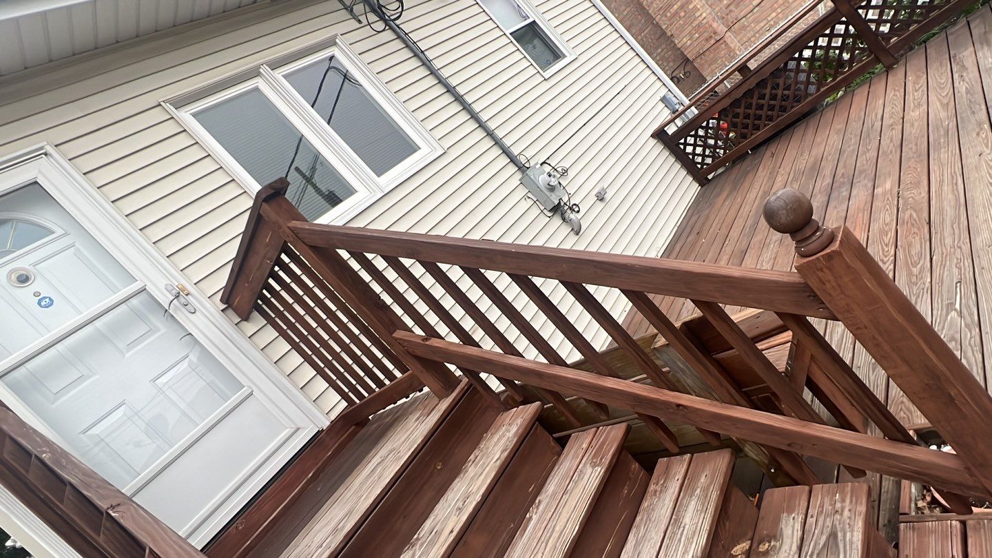 Wood cleaning and staining using Armstrong cloark oil stain by Northern Power Washing LLC.
