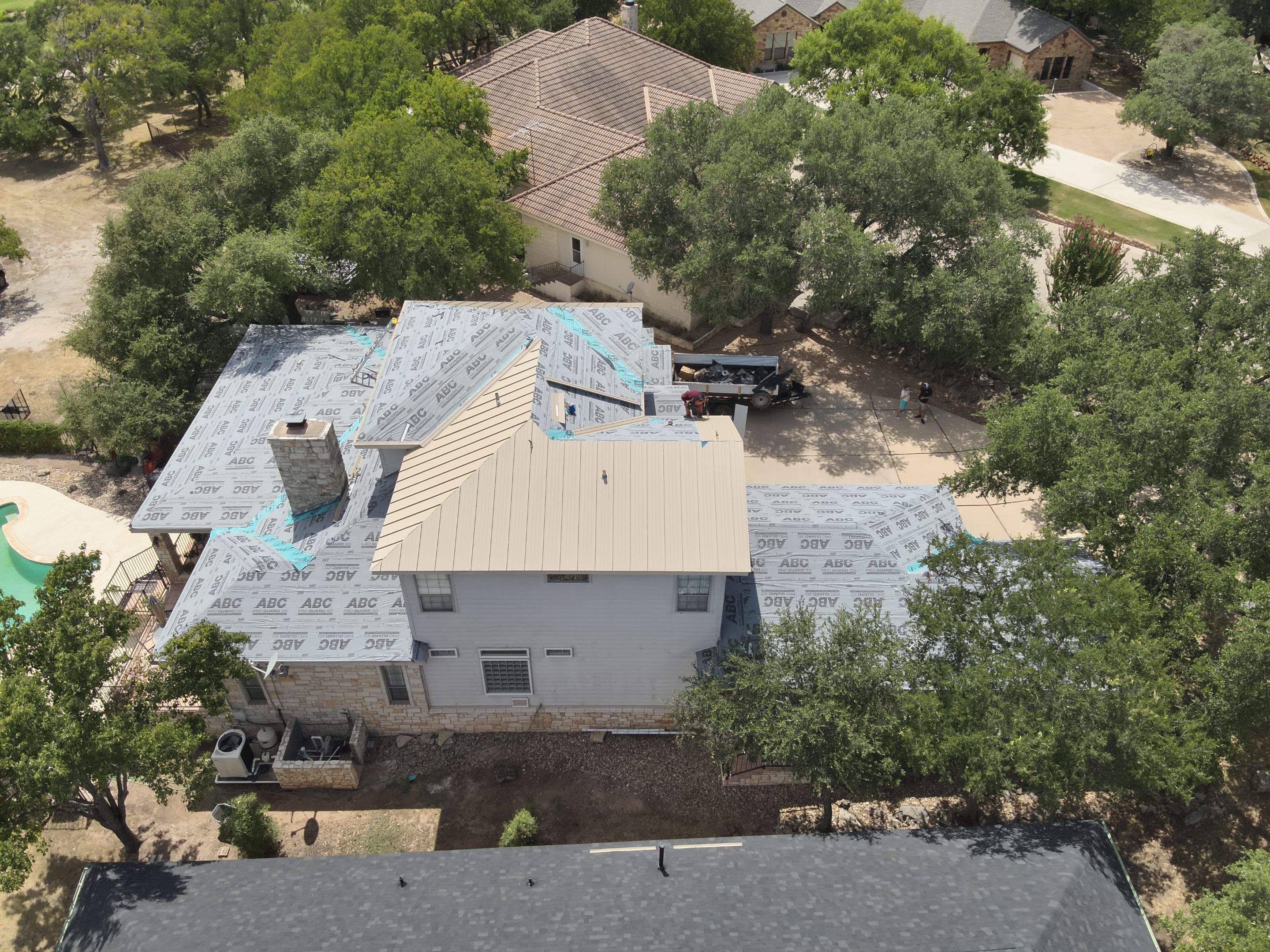 Residential Roof Replacement using 24 GA Double-Lock - Surrey Beige by Action Exteriors Austin