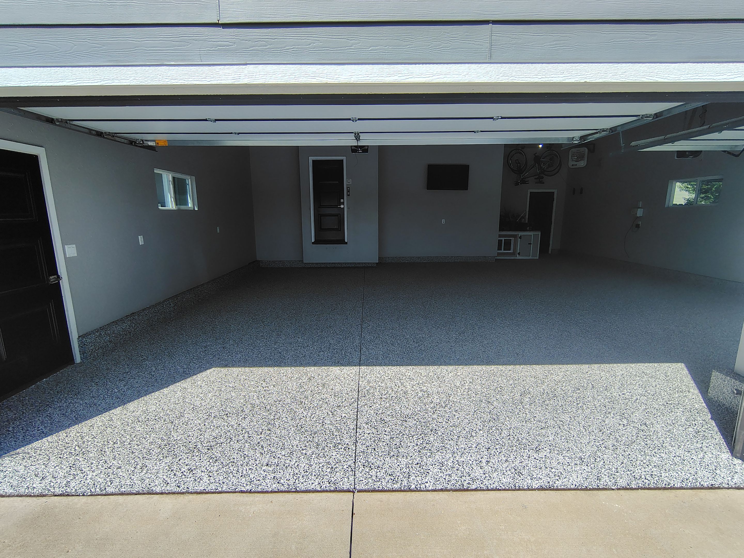 Custom Gray Flake Garage Floor Coating in Sioux Falls by Select Painting, Coatings & Garage Cabinets