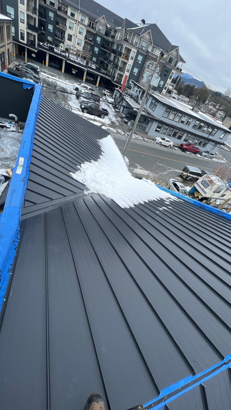Commercial Roofing Installation using 12" Prolok metal and hidden gutters! by Top Notch Roofing Inc