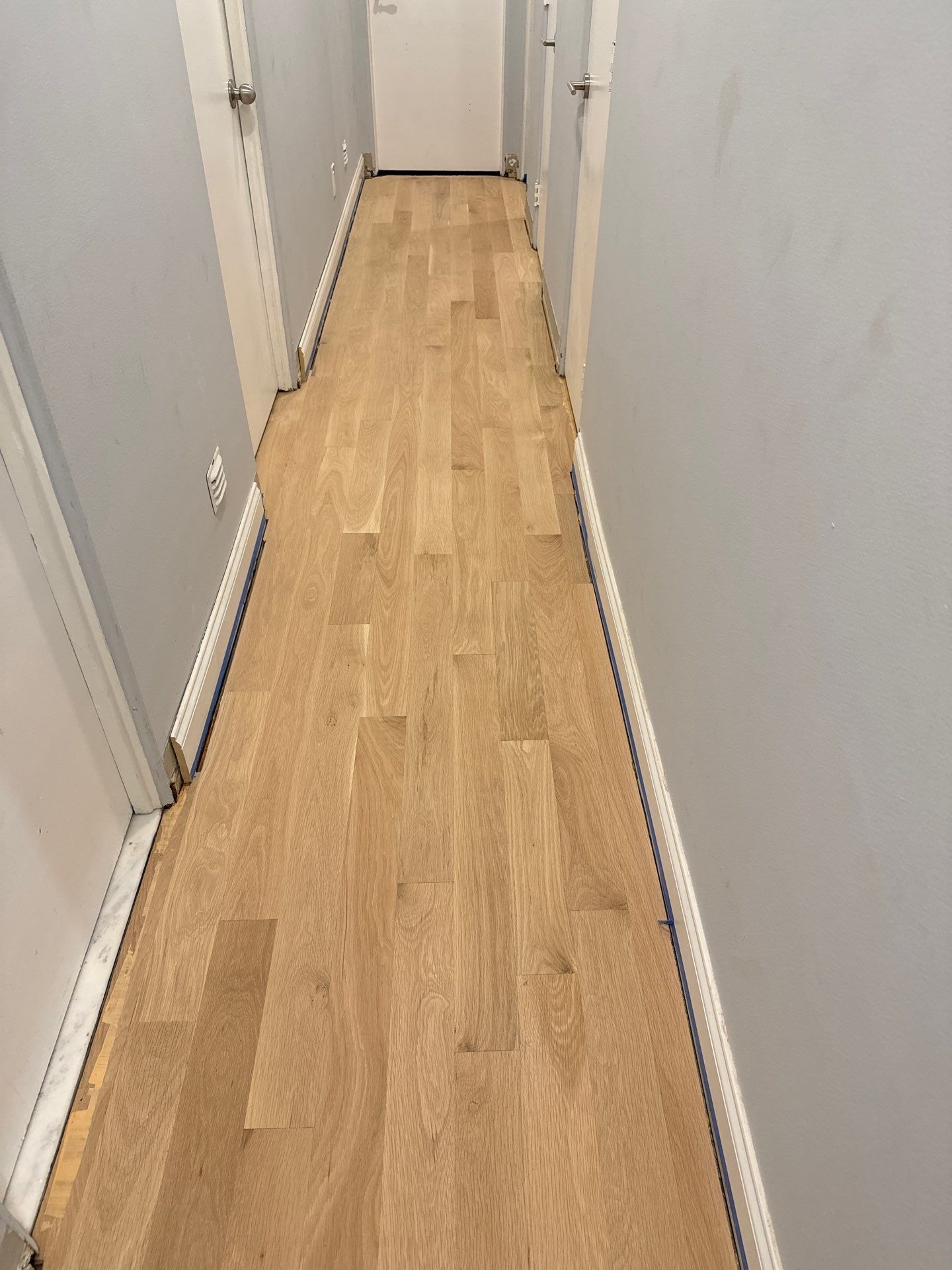 New Flooring installation using 4" White oak select grade plain sawn Ebony Stain by Ann Arbor Hardwoods