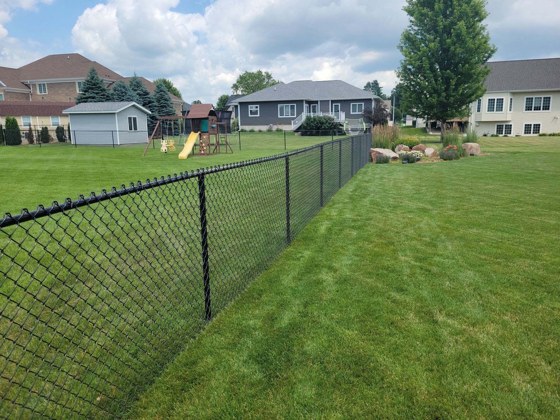 Black Vinyl Coated Chain Link Fence Installation in Cedar Falls by Perfect Picket Fence and Stain