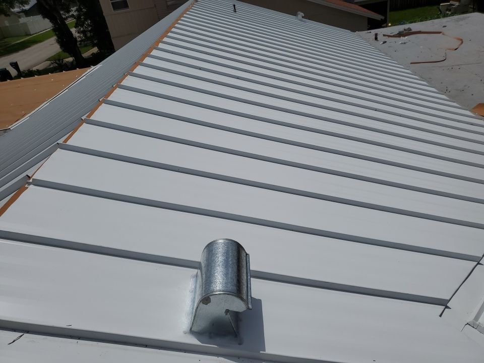 Residential Roofing Installation using 1.5" Nail Strip 24ga Solar White Kynar Coated Standing Seam Metal Panels by Morton Roofing, Inc.