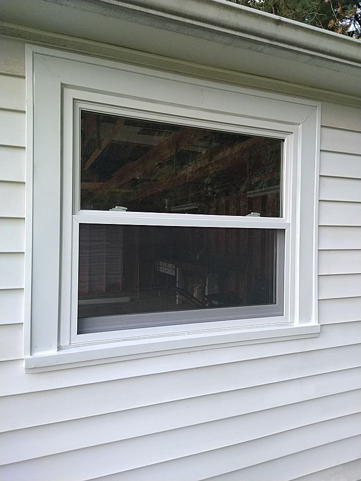 Siding Installation using Norandex woodsman dl-5 white woodgrain vinyl by Absolute Roofing and Construction