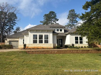 Conroe Elegance: Stucco, Foam Corbels, and Natural Stone Accents.