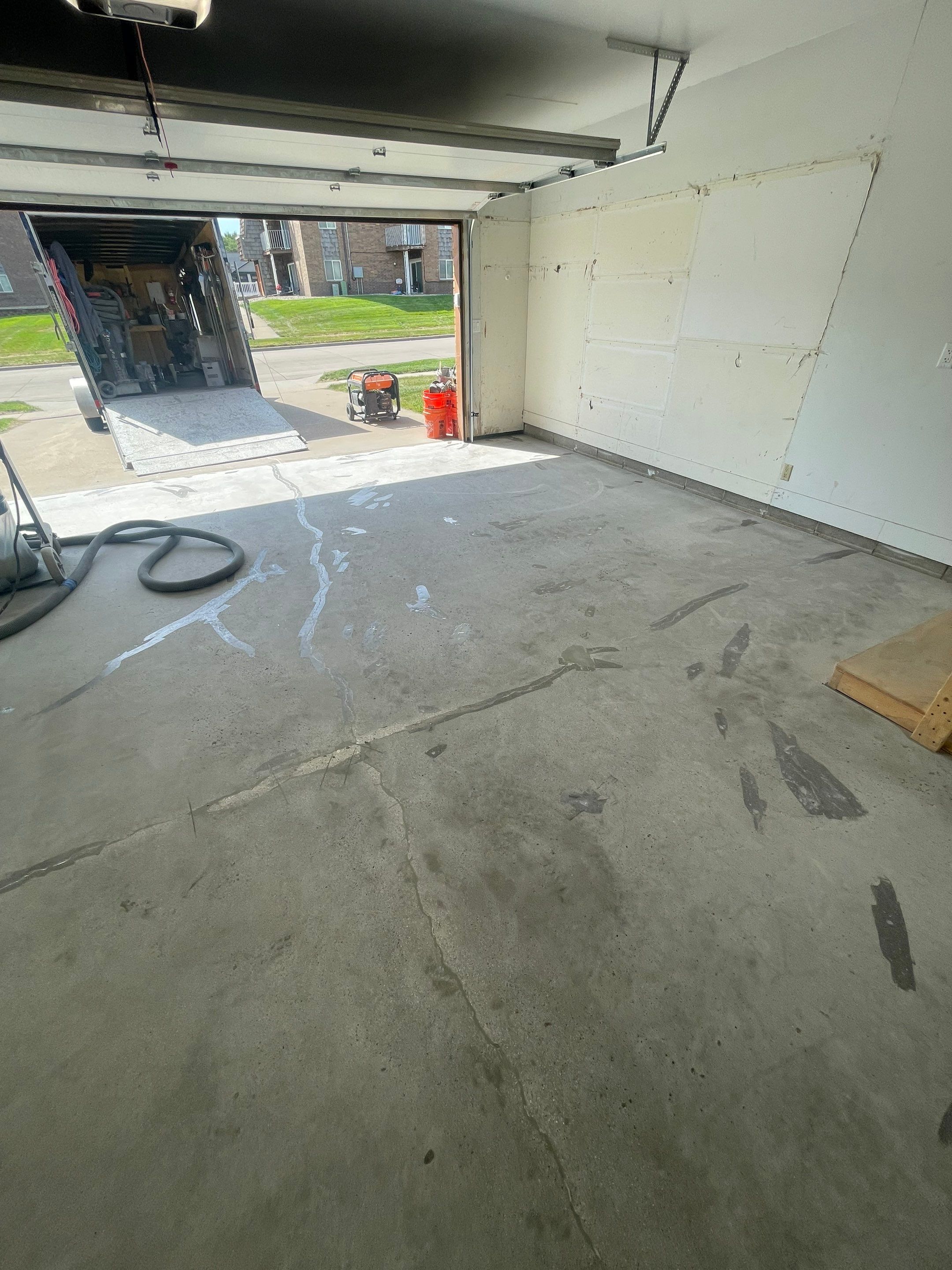 Grey Speckled Concrete Coating for Residential Garage in Yankton by Select Painting, Coatings & Garage Cabinets