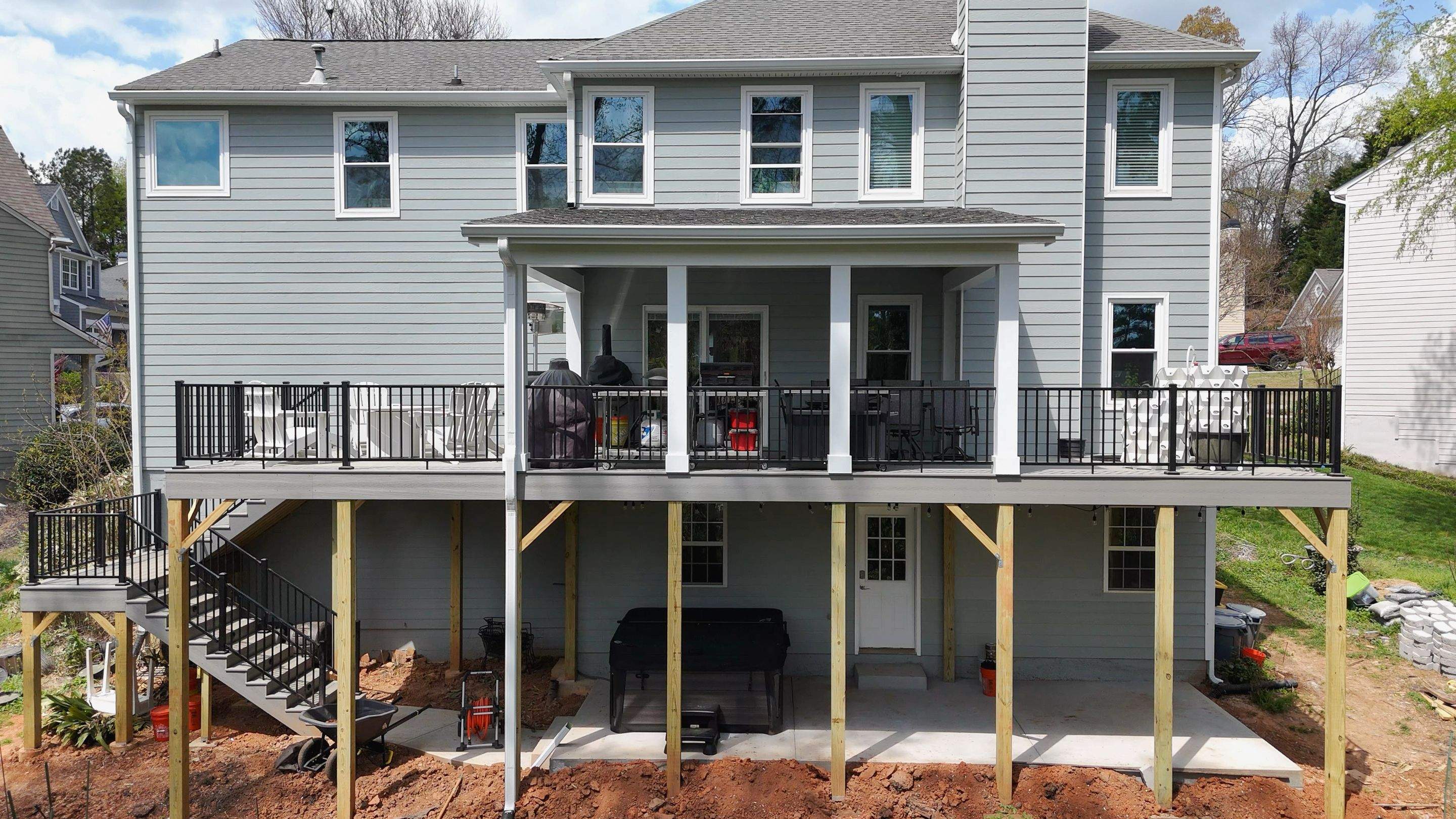 Covered Porch and Deck Build using Deckorators Venture Series Decking and Trex Select Aluminum Railing by Nelson Exteriors