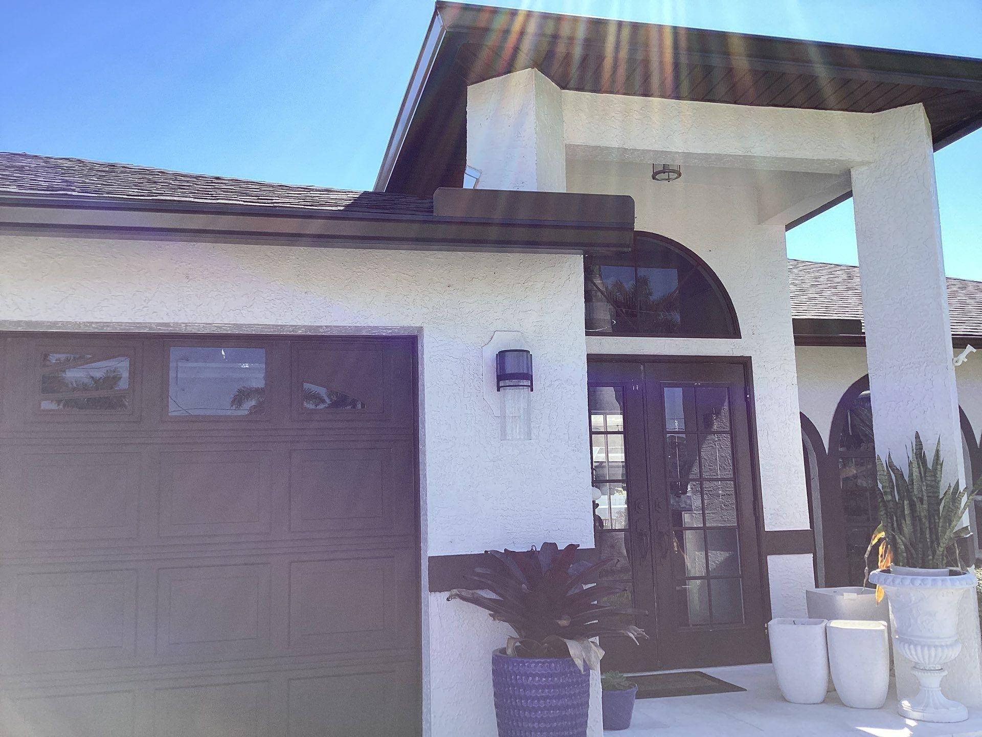 Brown Gutter + White and Brown Downspouts in Cape Coral FL by Gutter Professors