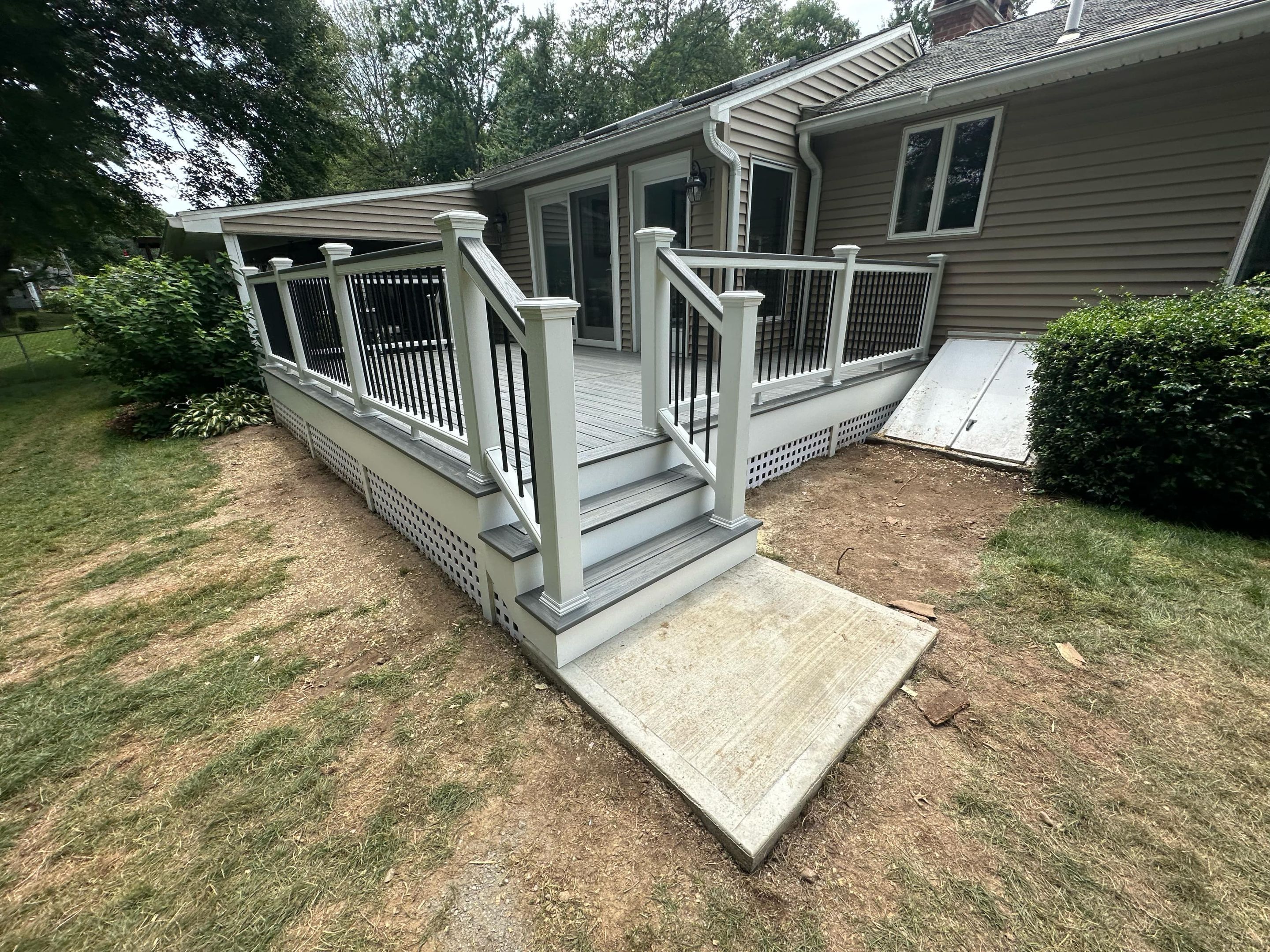 Deck Replacement with Trex Tropical Island Mist , matching cocktail rail and lattice bottom by DiGiorgi Roofing and Siding Inc