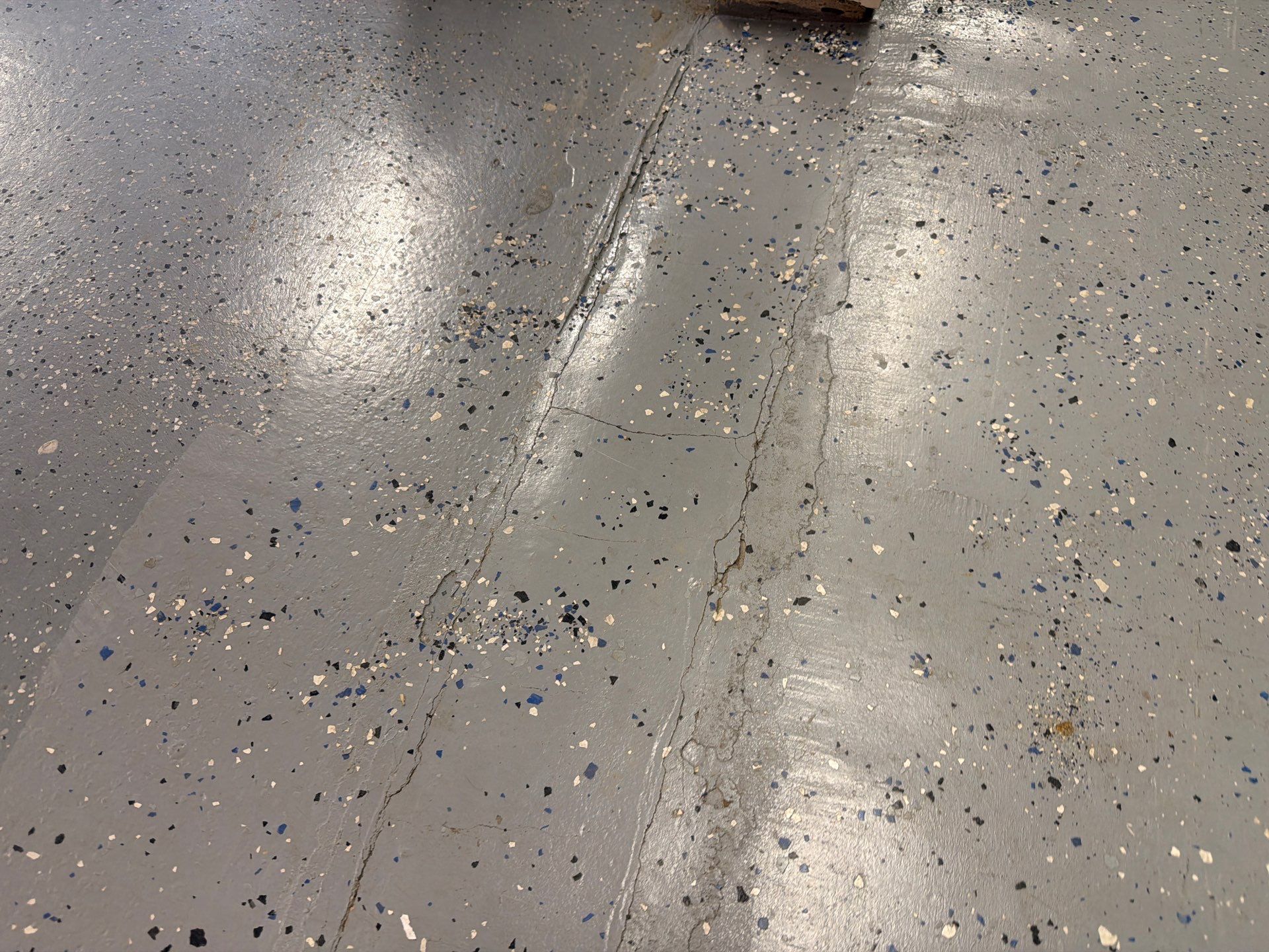 Custom Grey Flake Epoxy Garage Floor Installation in Remsen by Select Painting, Coatings & Garage Cabinets