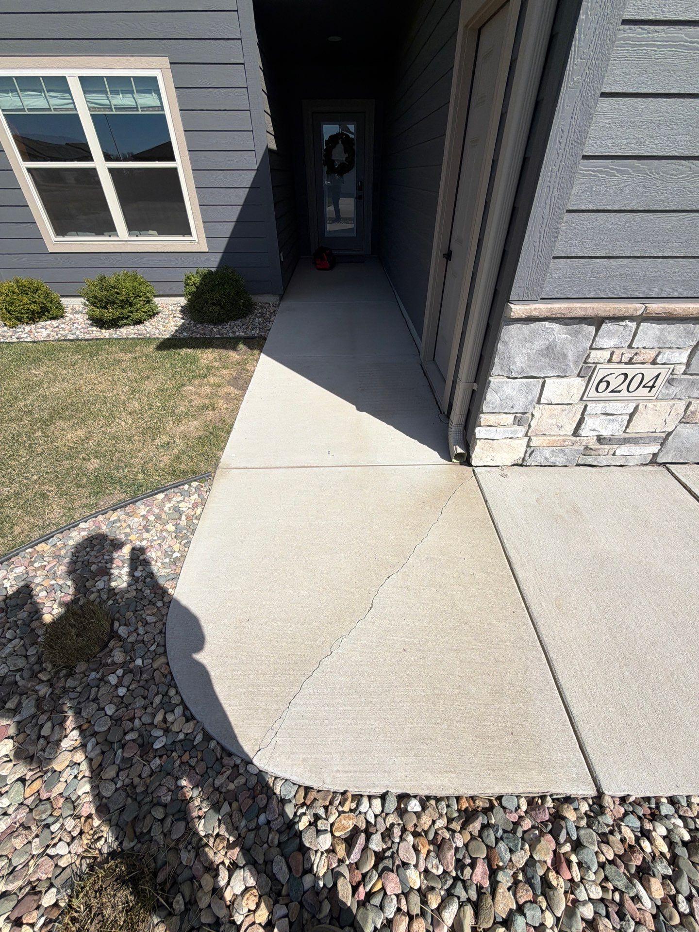 Textured Concrete Patio Coating and Custom Privacy Pergola in Sioux Falls by Select Painting, Coatings & Garage Cabinets