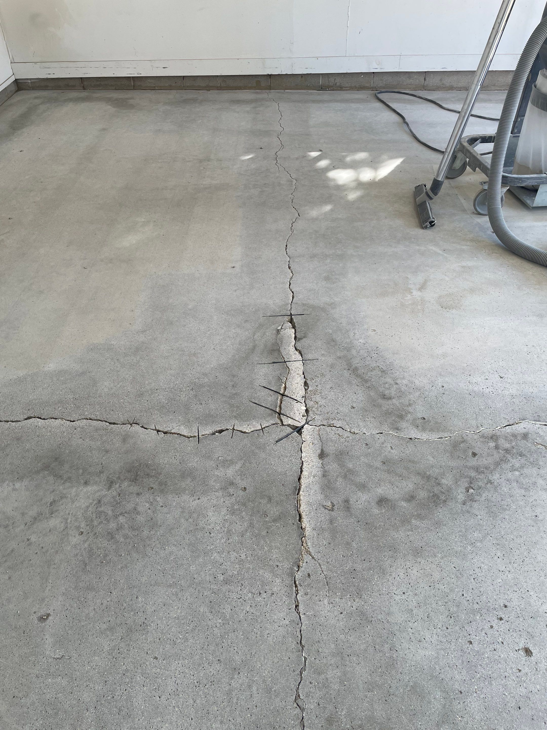 Grey Speckled Concrete Coating for Residential Garage in Yankton by Select Painting, Coatings & Garage Cabinets