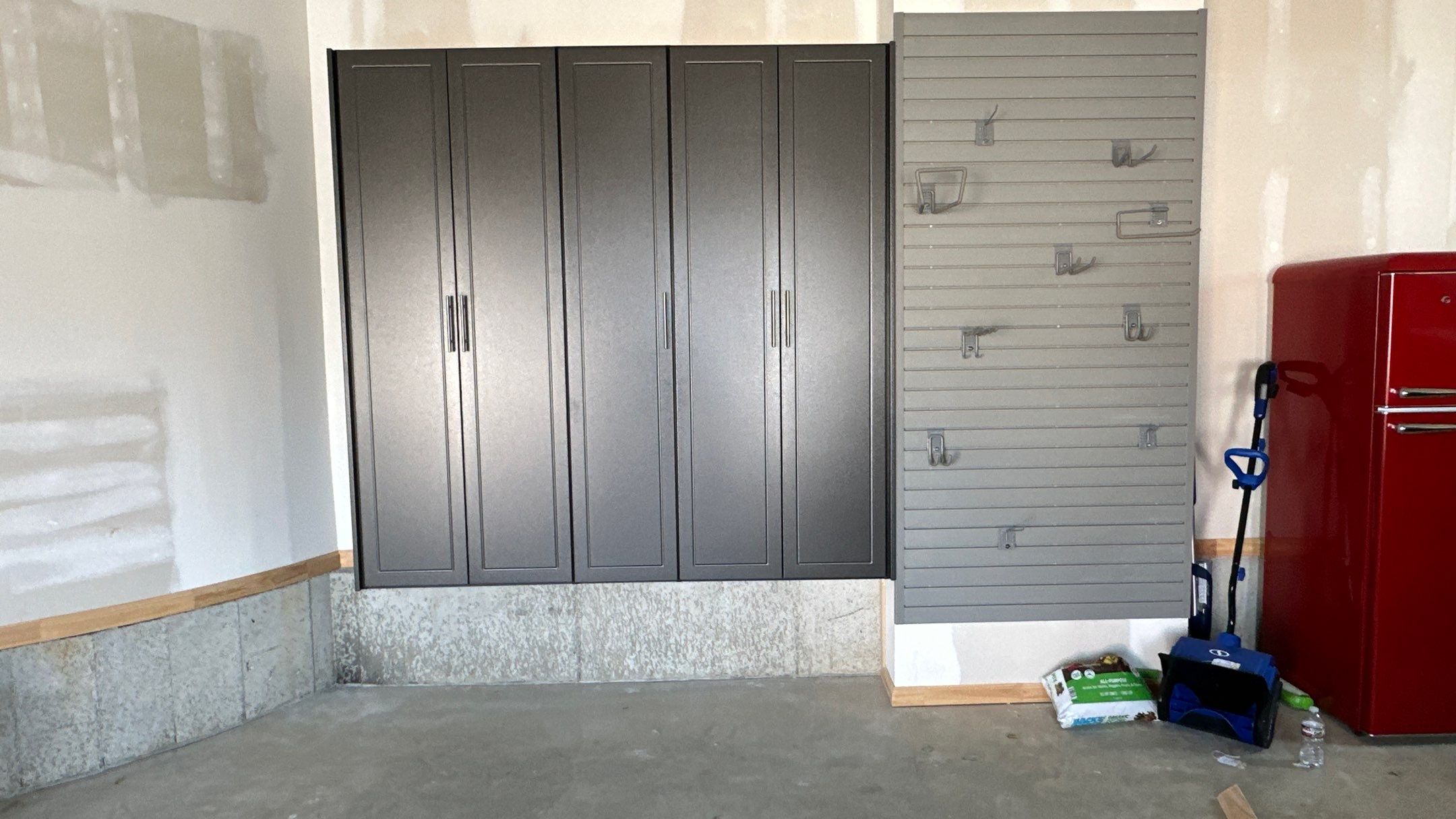 Megan J. added cabinets and slotwall to her garage. Plus a New Floor by Banner Garage