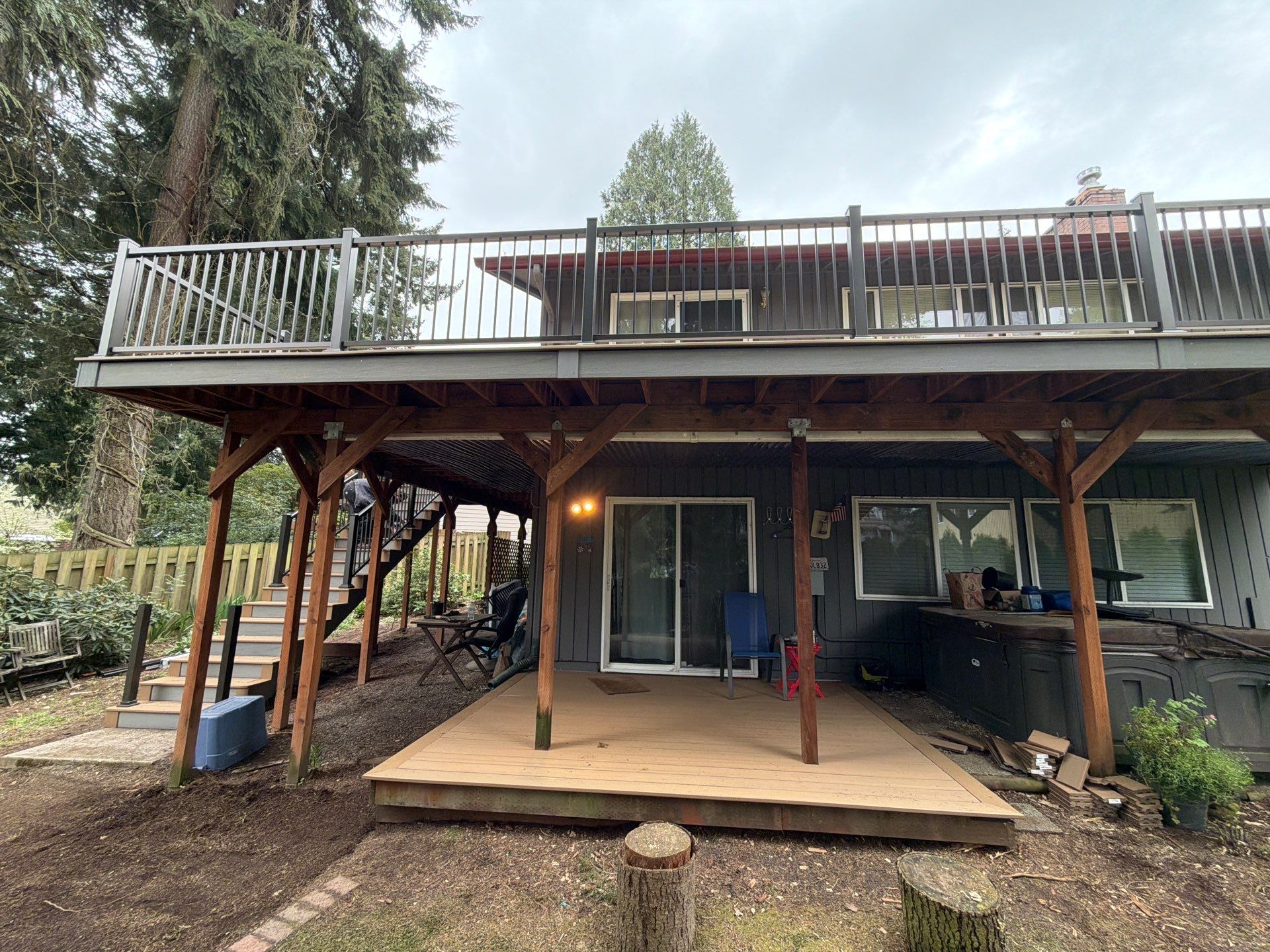 Elevated TimberTech Composite Deck Replacement With Black Metal Railings by Emerald City Energy