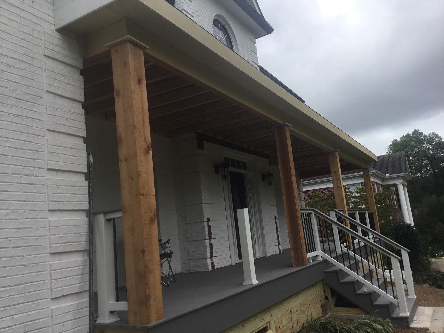 Custom Front Porch Construction with White Railing in Dunwoody by Swift Home Renovations
