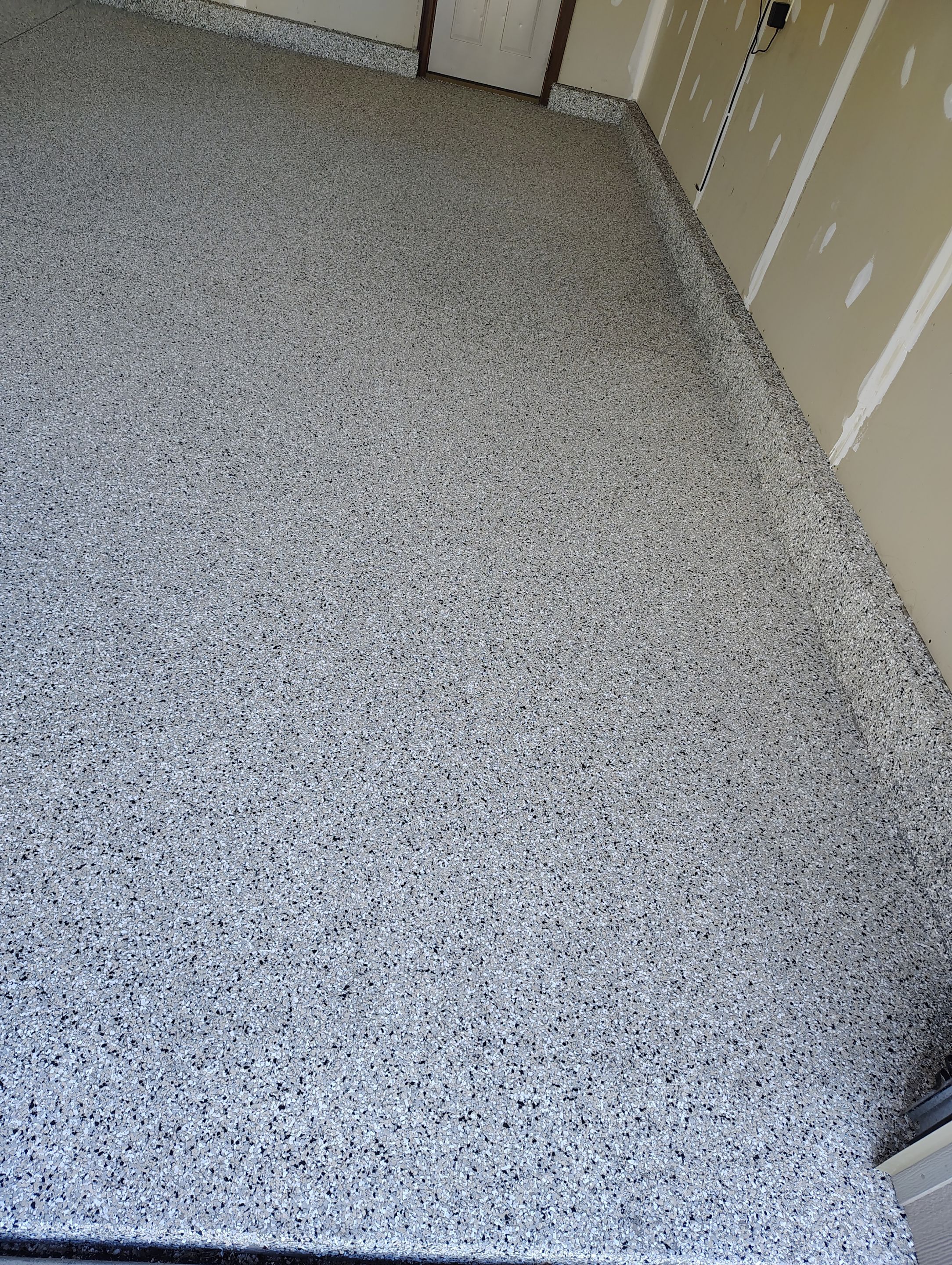 Multi-Car Garage Concrete Coating and Epoxy Finish in Sioux Falls by Select Painting, Coatings & Garage Cabinets