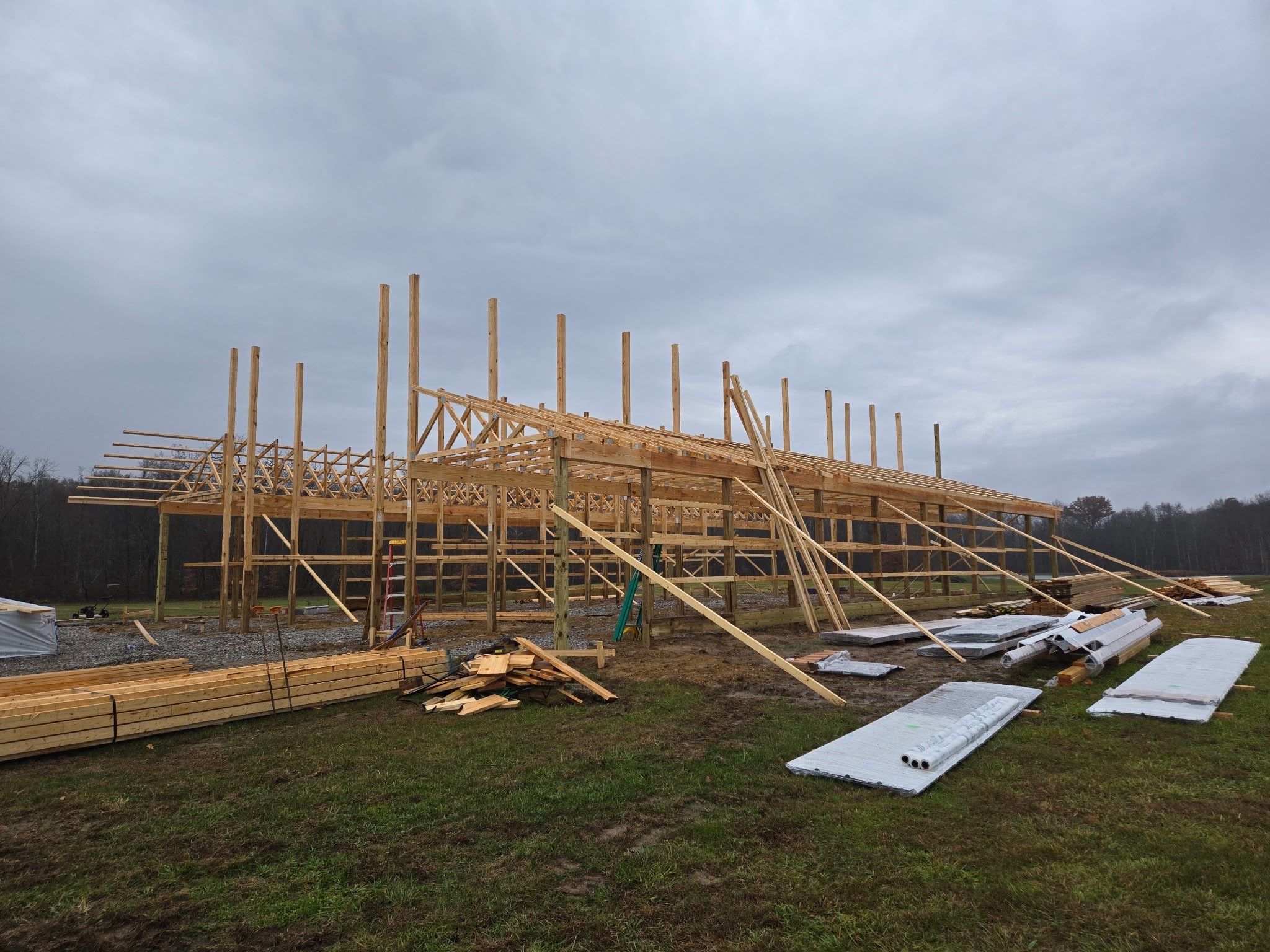 Custom Pole Barn Home with Charcoal Siding and Copper Roof by The Barn Builders