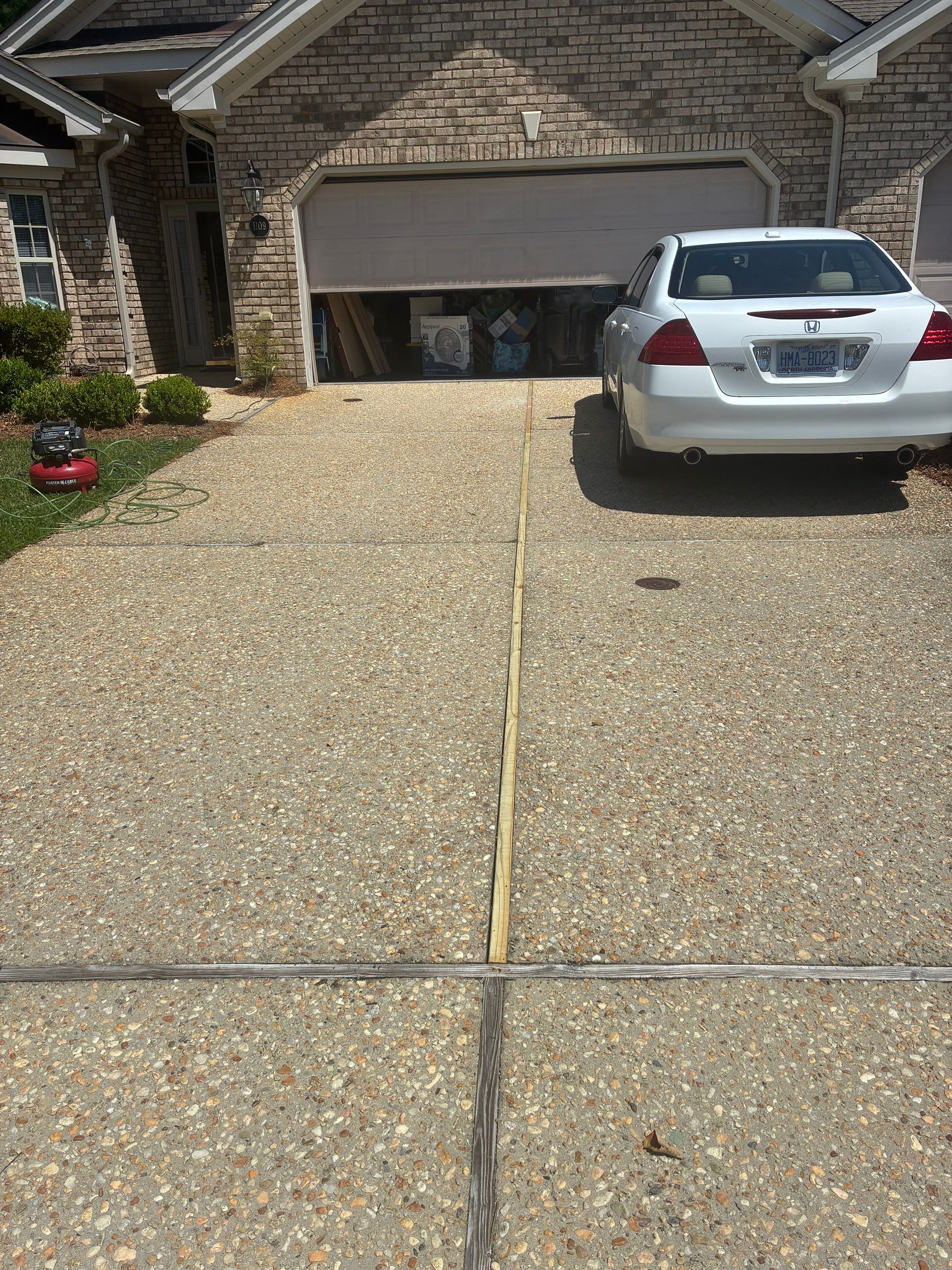 Exposed Aggregate Driveway Joint Repair in Jefferson Landing, Leland, NC by RGR Construction and Roofing, LLC