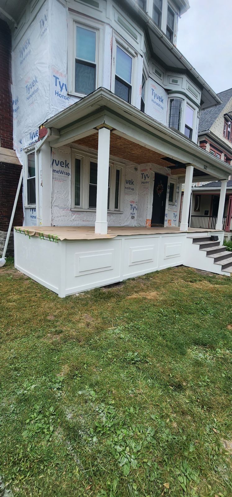 Exterior Renovations- Siding, Stamped Concrete, Porch, and Railings by Ivy Lea Construction