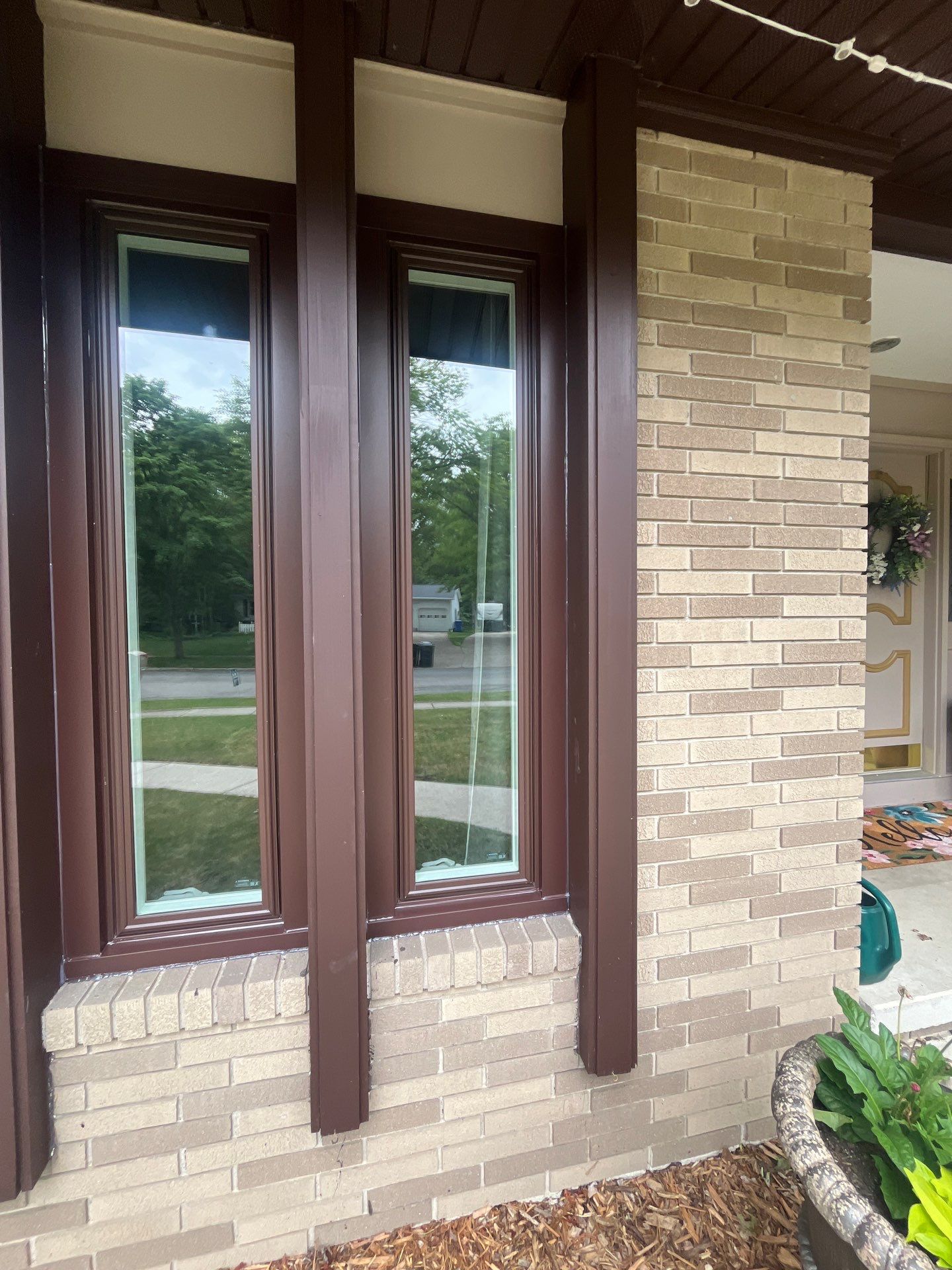 Dark Brown Window Installation for Midland Brick Ranch Home by Great Lakes Home Design LLC