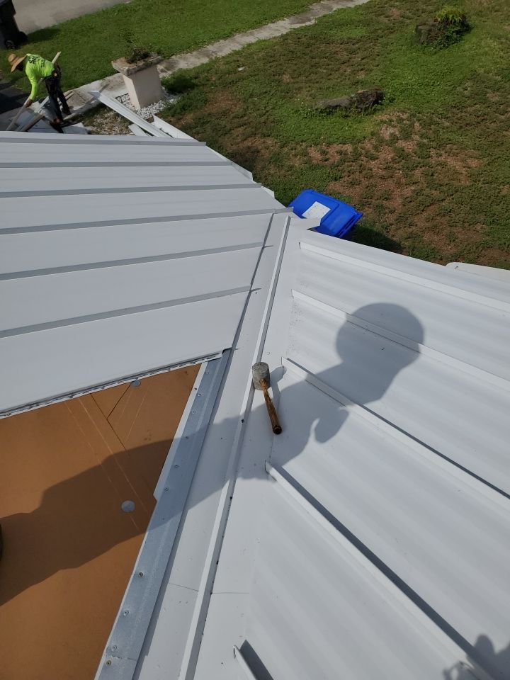 Residential Roofing Installation using 1.5" Nail Strip 24ga Solar White Kynar Coated Standing Seam Metal Panels by Morton Roofing, Inc.