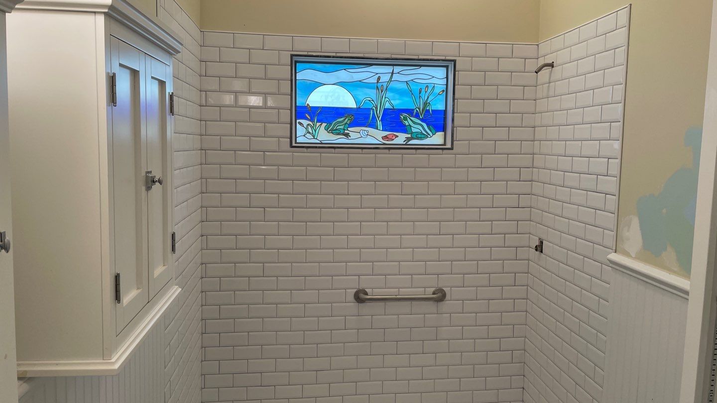 Shower Transition Highlighting Stained Glass Window by Footprints Floors of Coastal Carolina