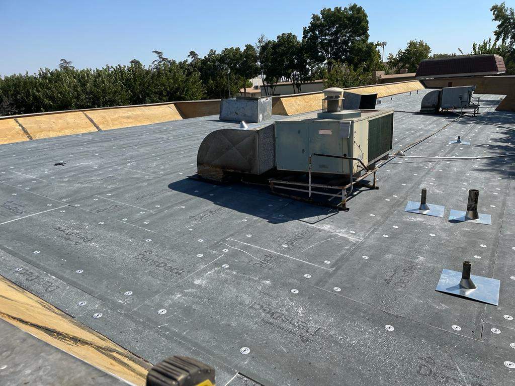 Commercial Roofing Installation using General Coatings acrylic coatings and spray foam by Straight Edge Roofing Inc