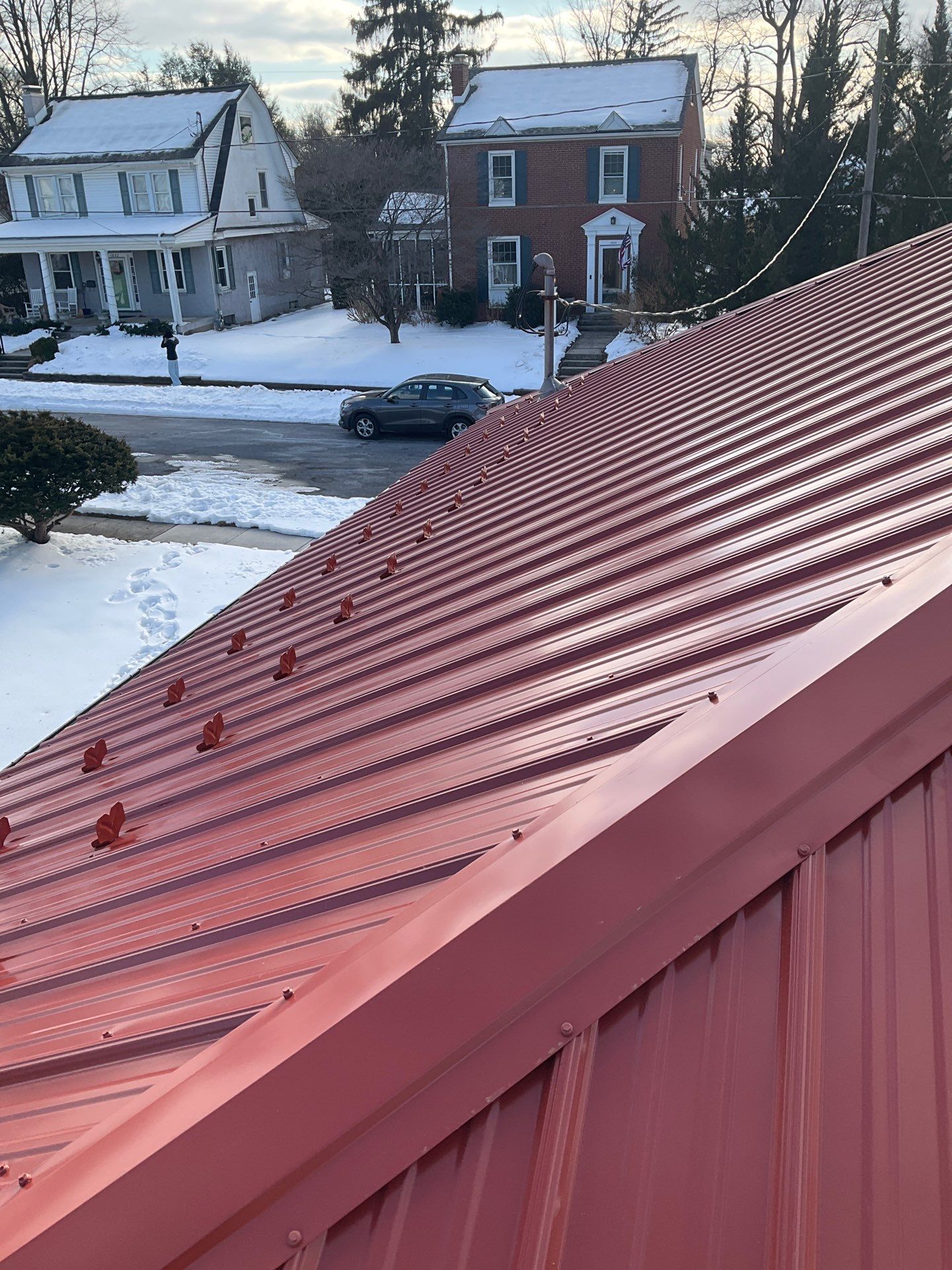 Red Metal Roofing Upgrade for Brick Home by Esh Builders