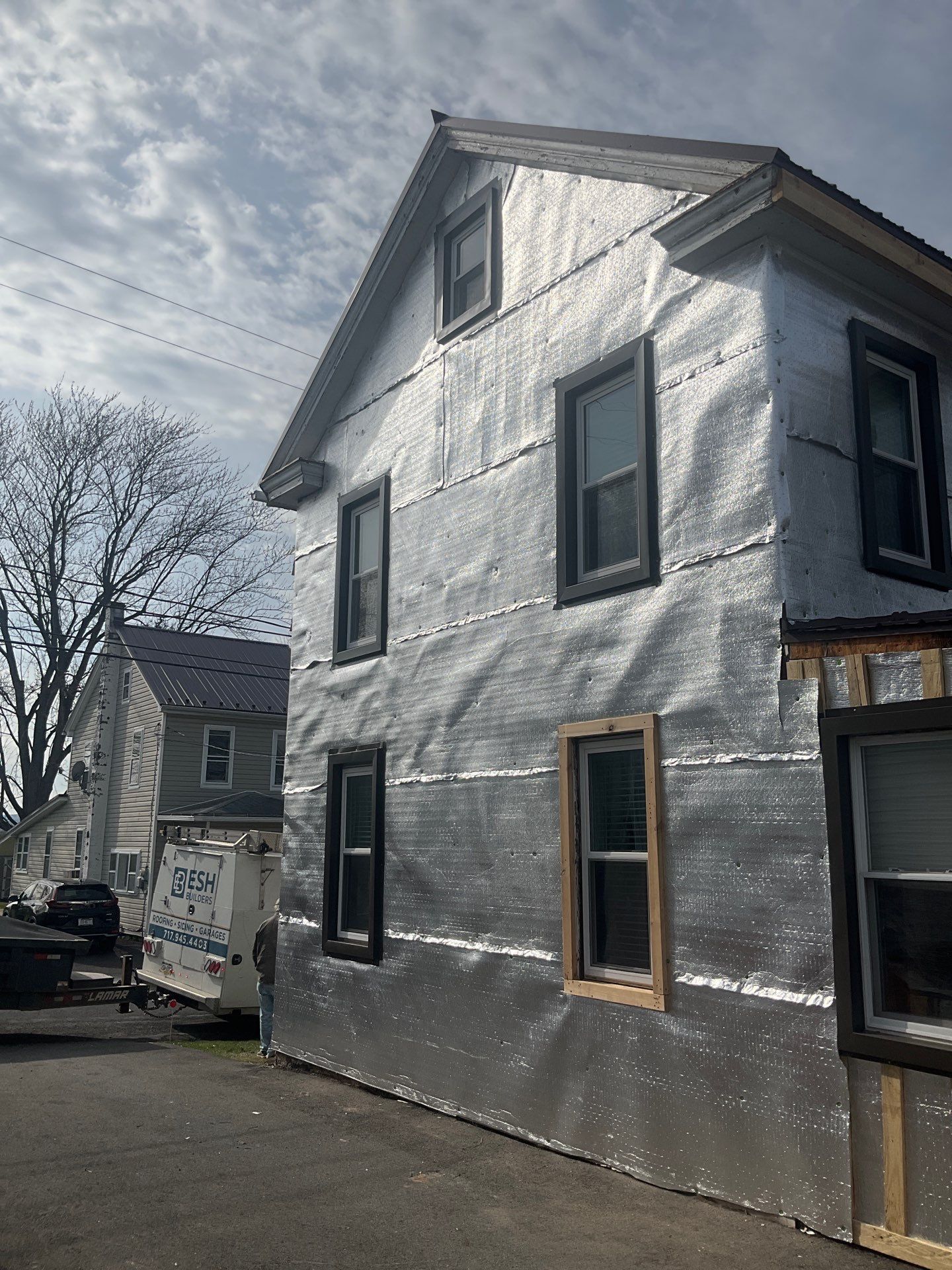 Exterior Renovation with Vinyl Siding, Metal Roof & Spouting  by Esh Builders