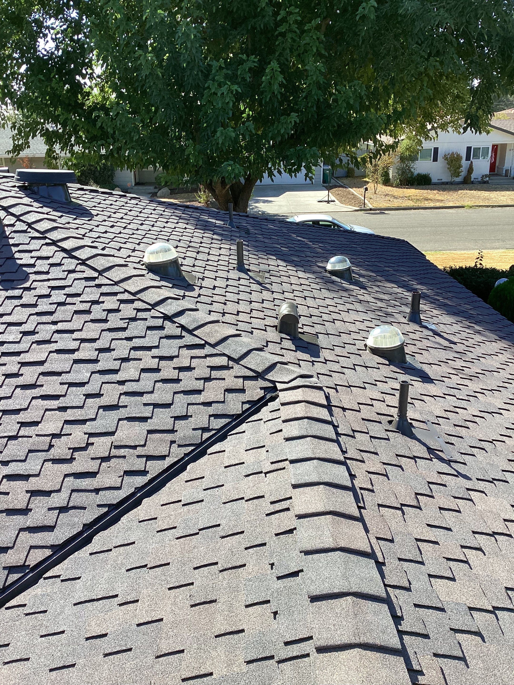 Installation of Certainteed Presidential shingles on residential house by Straight Edge Roofing Inc