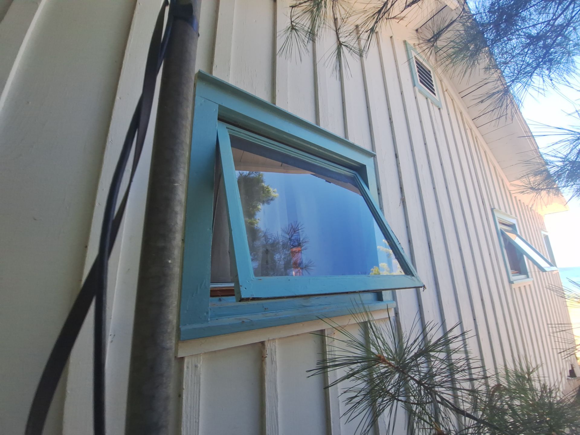 Lakeside Cottage Exterior Painting and Teal Trim Restoration in Mears by Gordon Painting