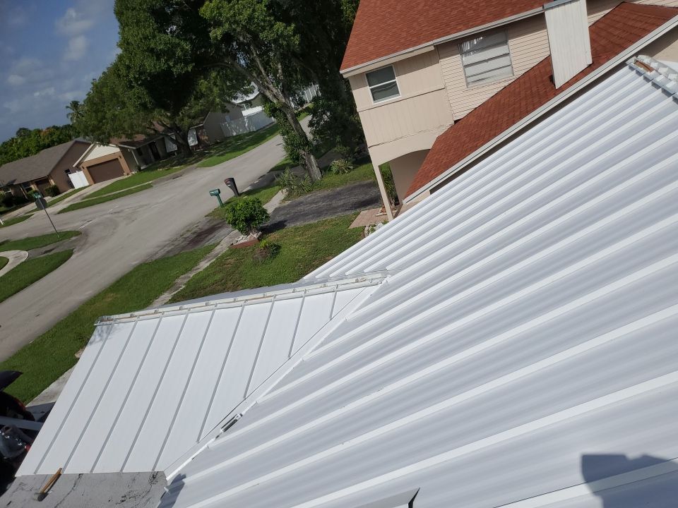 Residential Roofing Installation using 1.5" Nail Strip 24ga Solar White Kynar Coated Standing Seam Metal Panels by Morton Roofing, Inc.