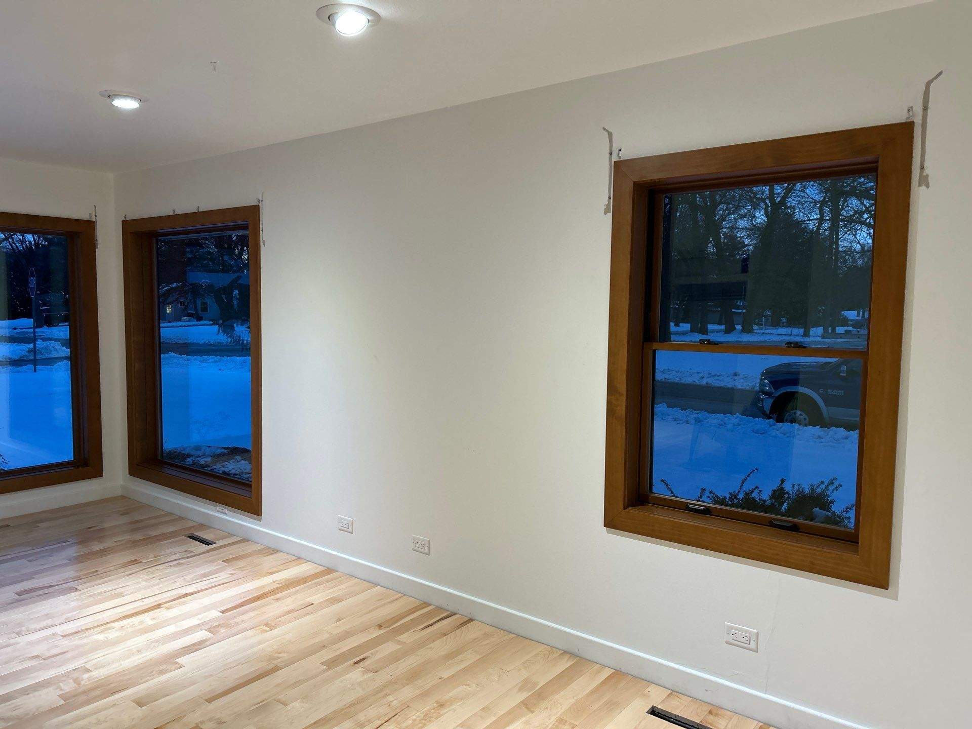 Black-Frame Pella Lifestyle Upgrade on a Partial Brick Home by United Windows and Siding LLC