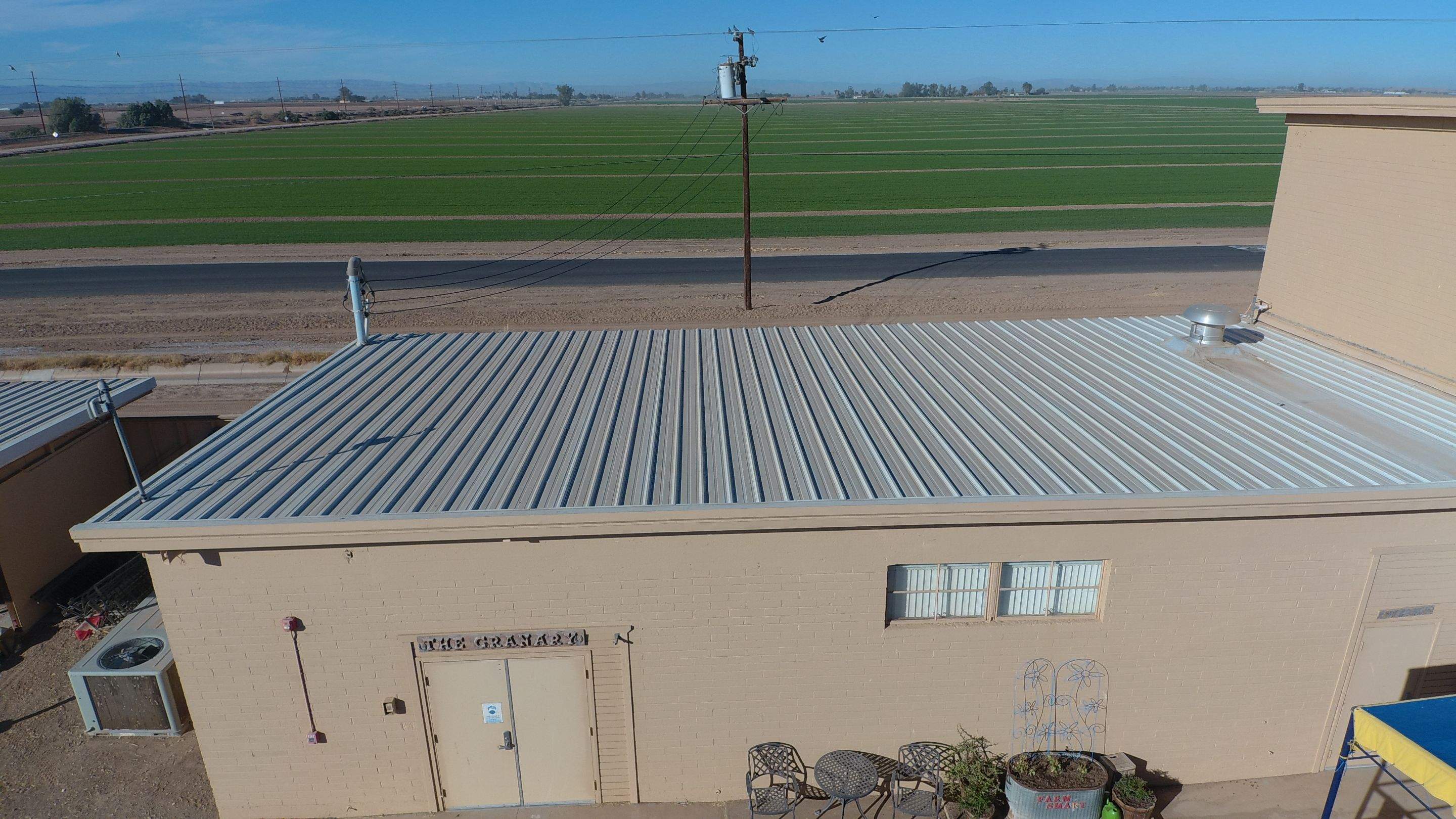 Metal roof restoration on commercial roof using Conklin Benchmark/PUMA XL fabric and coating by Straight Edge Roofing Inc