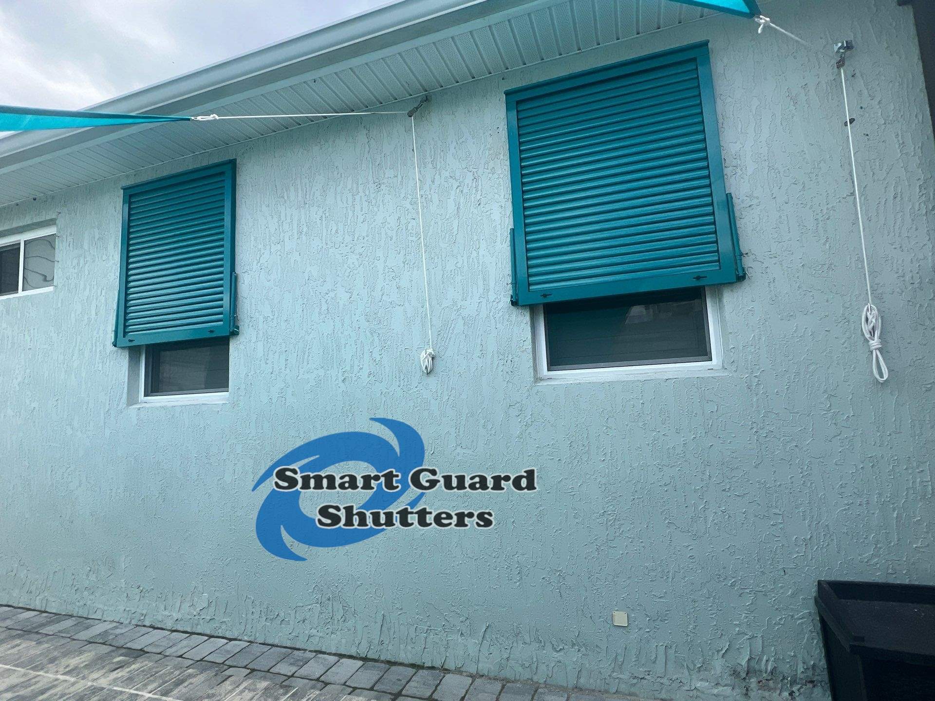 Impact Bahama Shutters in Water Blue by Smart Guard Shutters