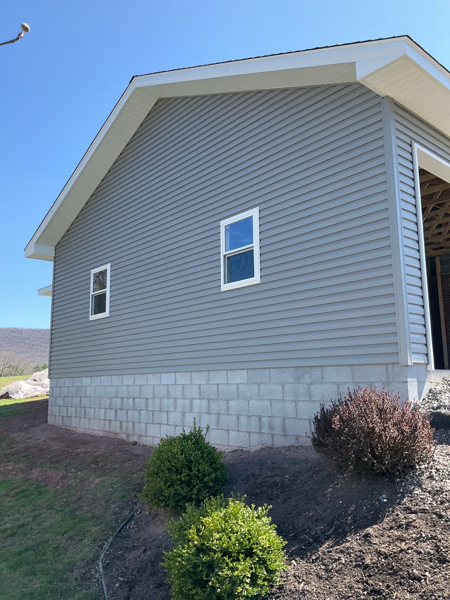 Tower City Residential Addition Featuring Gray Vinyl Siding and Garage by Esh Builders