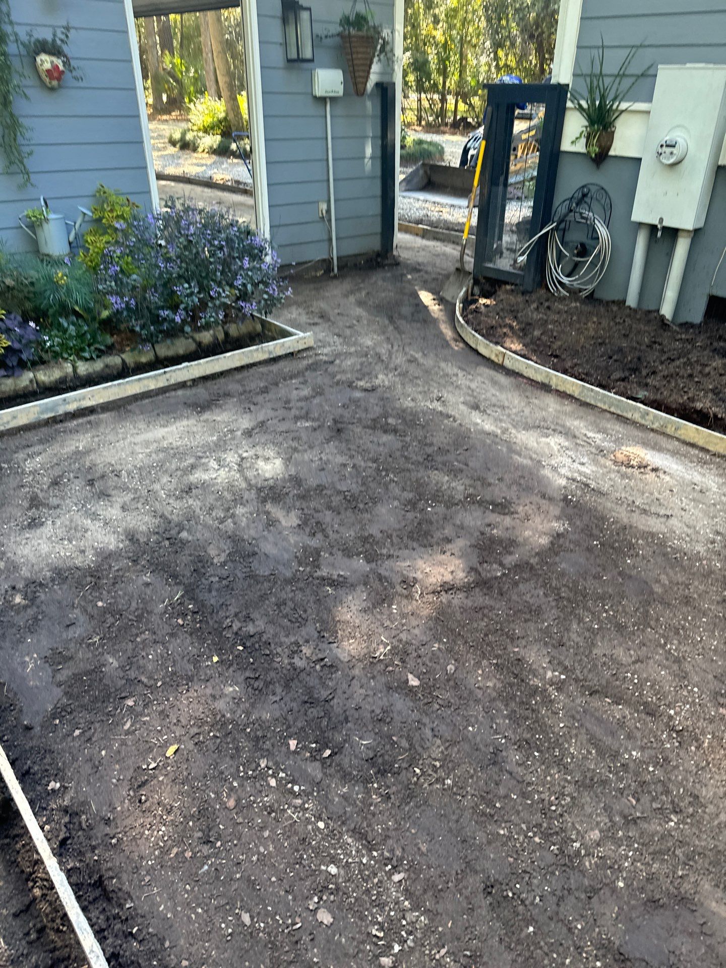 Concrete Driveway and Patio Installation With Decorative Brick Borders by Lowcountry Scapes, LLC