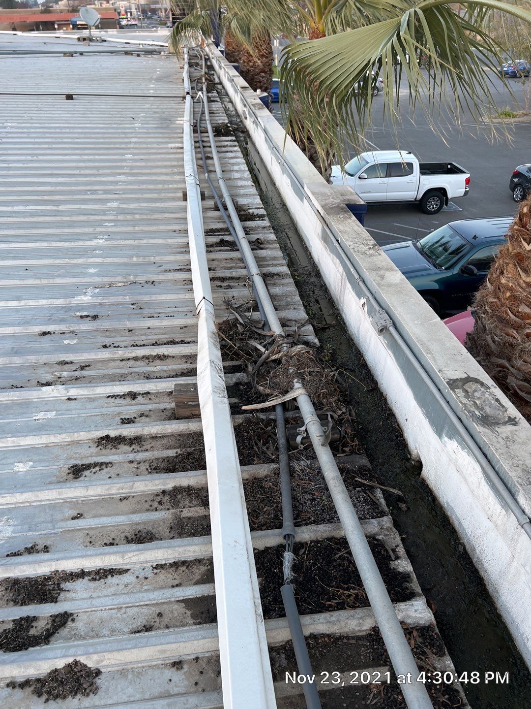 Metal roof restoration on commercial roof using Conklin Benchmark/ PUMA XL acrylic coatings over metal and foam by Straight Edge Roofing Inc
