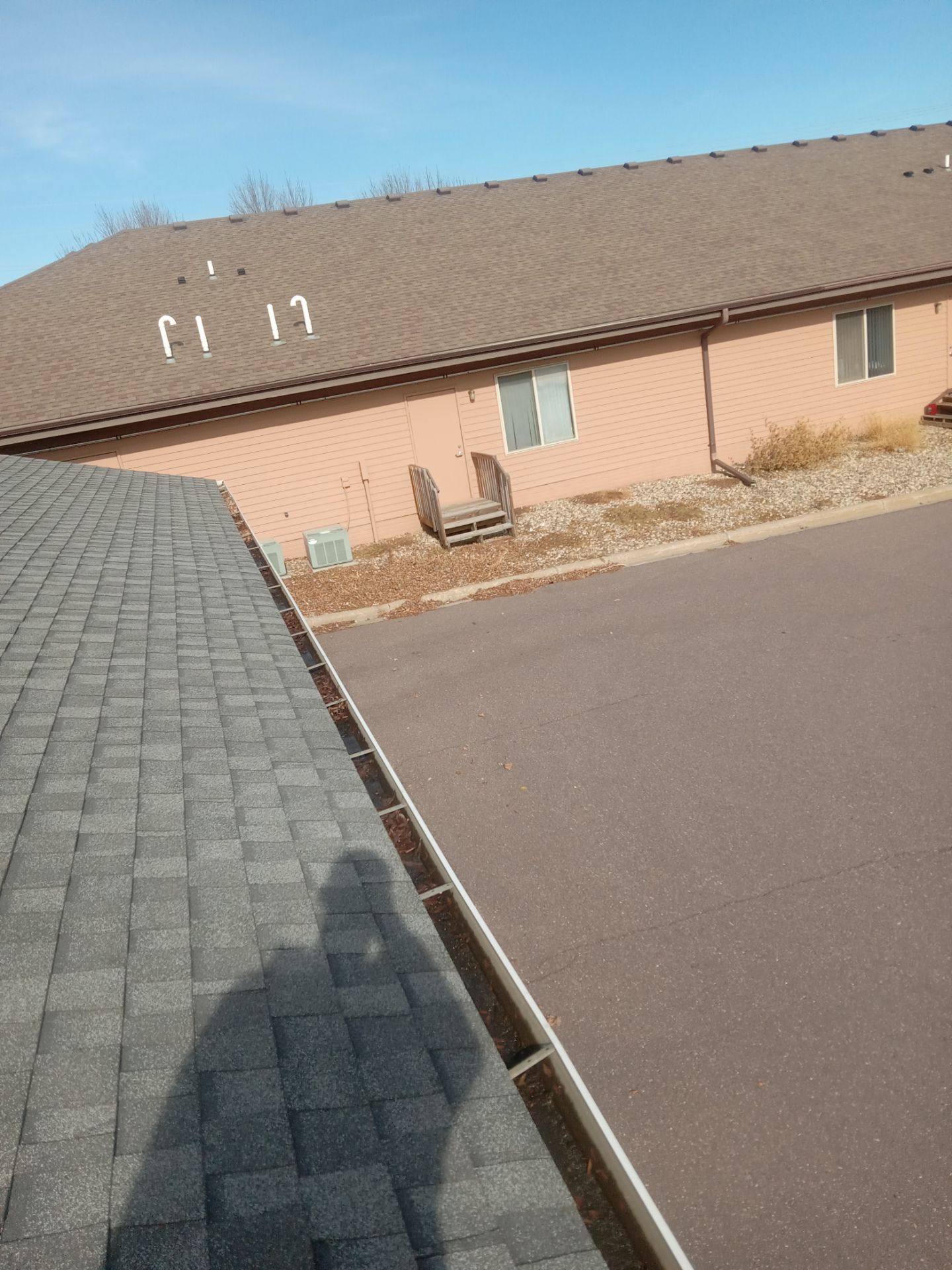Commercial gutter cleaning Sioux Falls, SD before photo with filled gutters