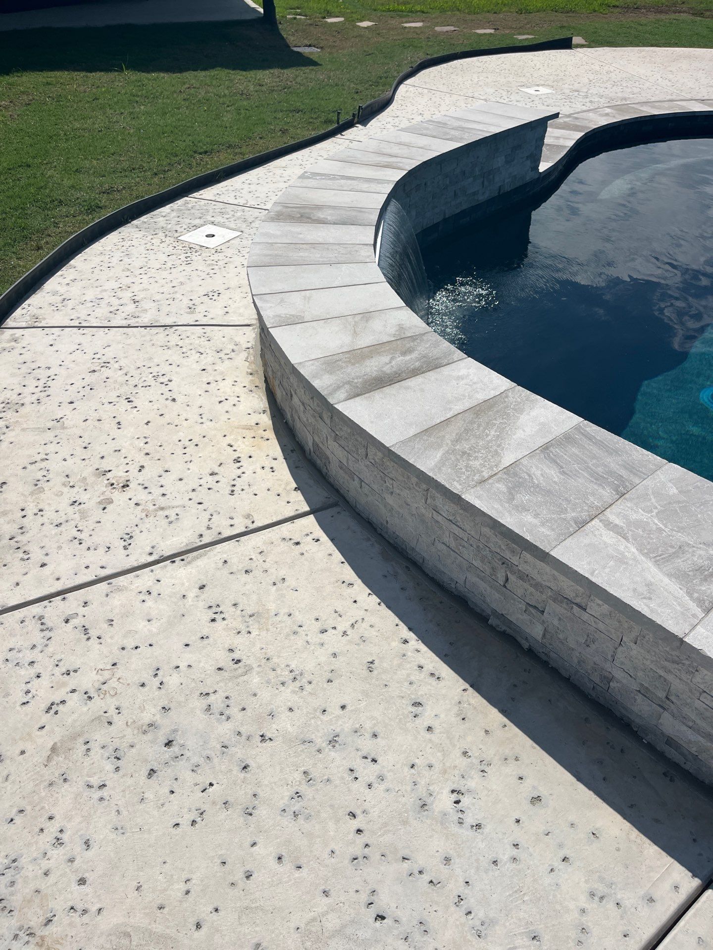 Freeform Pool with Raised Stone Spa Wall by Pinnacle Pools and Spas - DFW