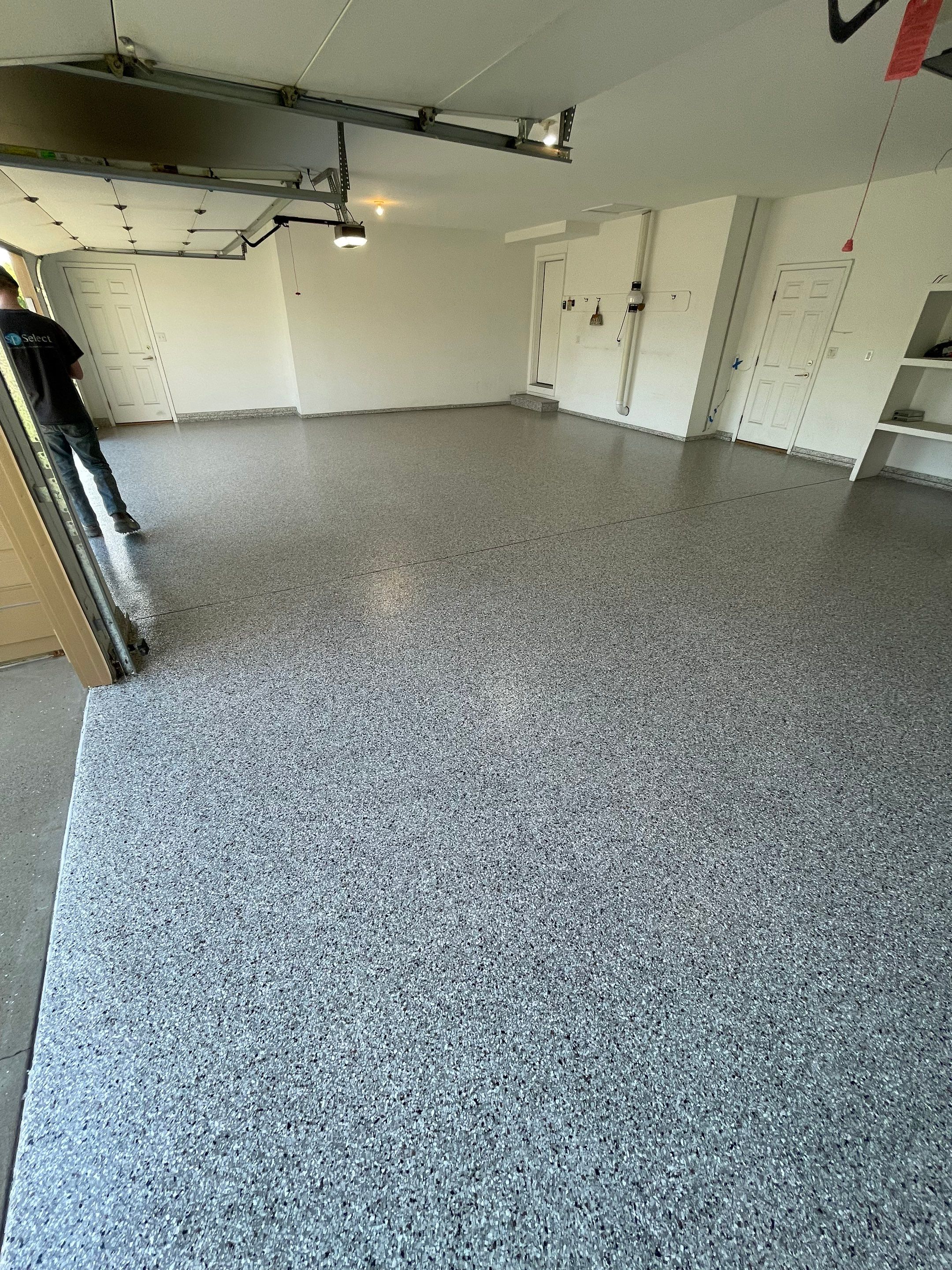 Yankton Garage Floor Restoration with Gray Speckled Epoxy Coating by Select Painting, Coatings & Garage Cabinets