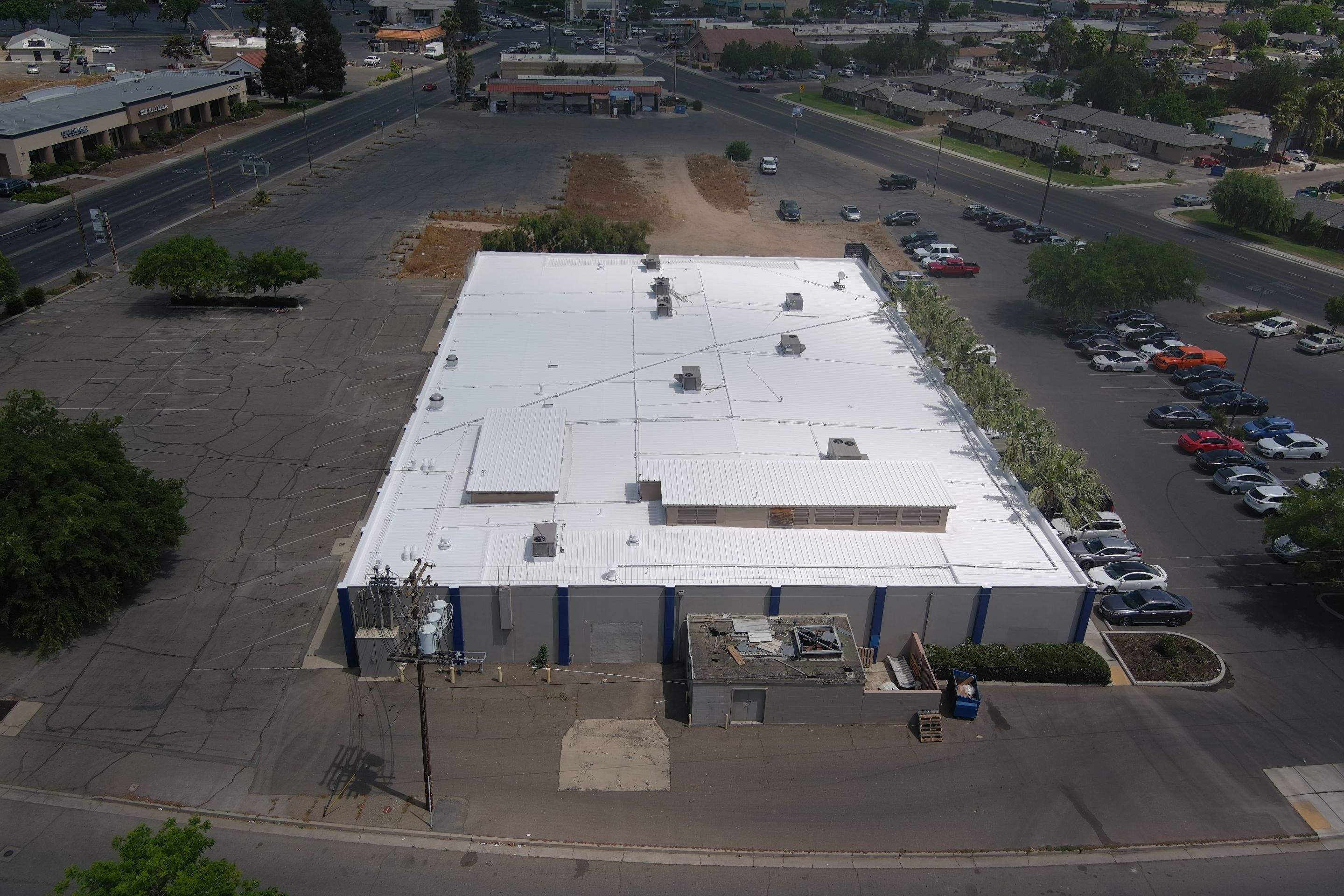 Metal roof restoration on commercial roof using Conklin Benchmark/ PUMA XL acrylic coatings over metal and foam by Straight Edge Roofing Inc