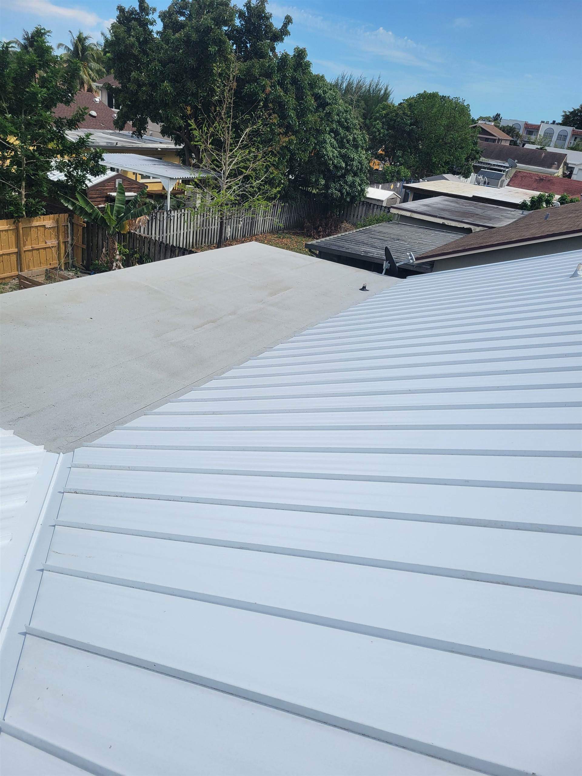 Standing Seam Metal & Flat Re-Roof using 1.5" Nail Strip 24ga Solar White Kynar Coated Standing Seam Metal Panels by Morton Roofing, Inc.