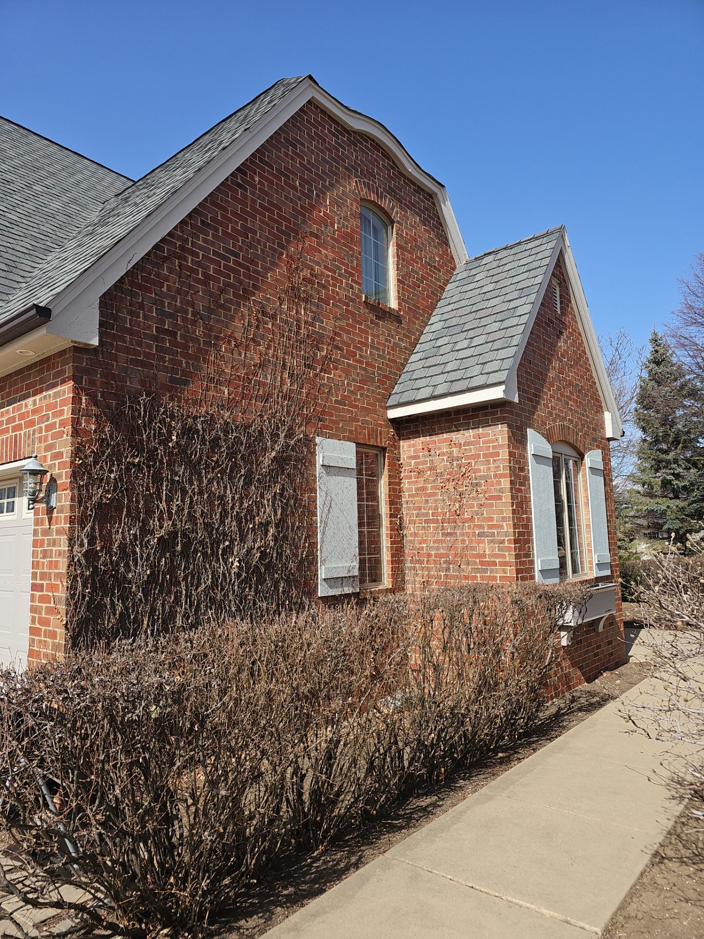 Residential Exterior Brick Painting and Limewash Refresh in Sioux Falls by Select Painting, Coatings & Garage Cabinets