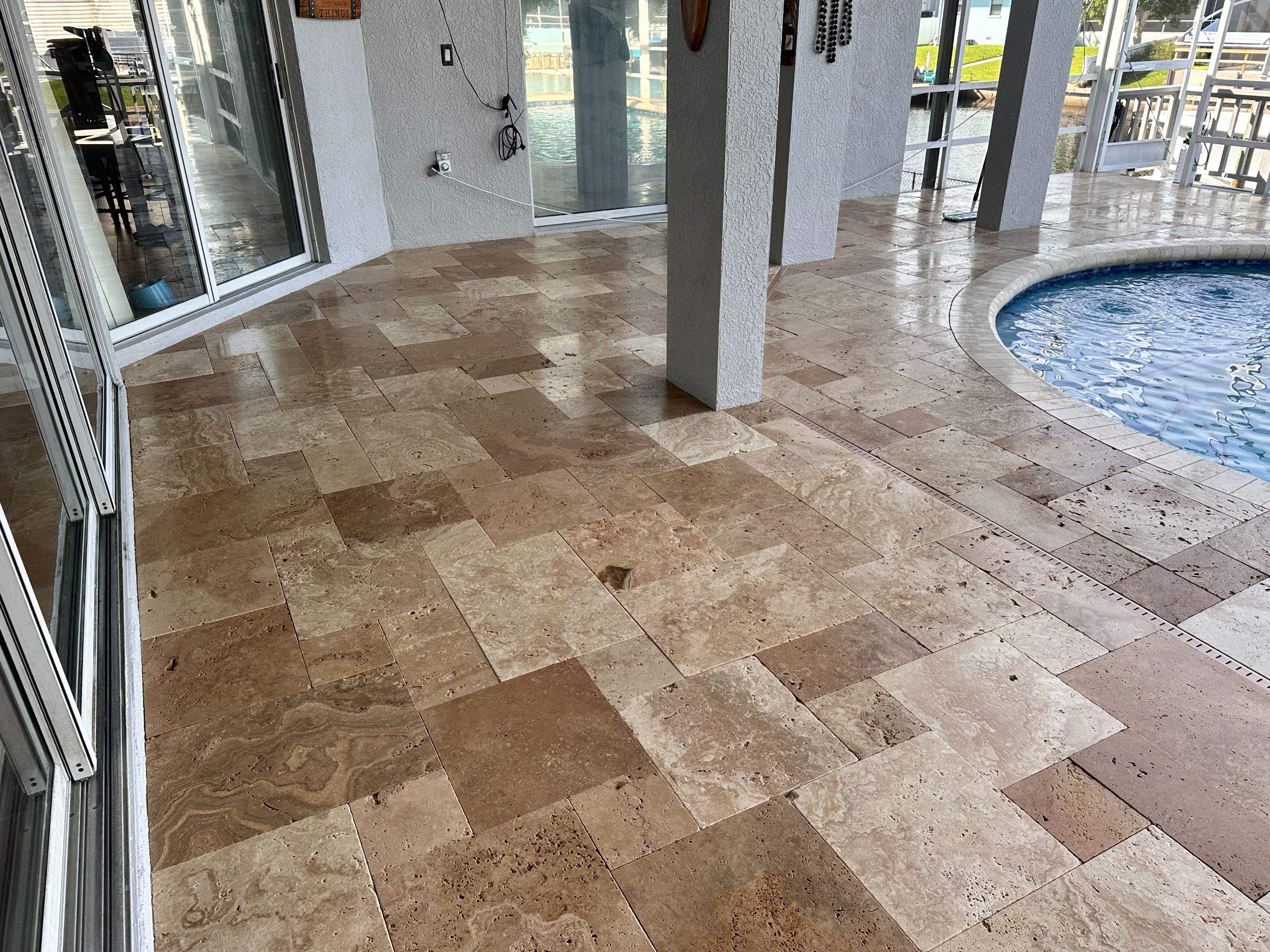Travertine Sealing and Stripping for a Waterfront Pool Deck in Apollo Beach by Supreme Paver Experts